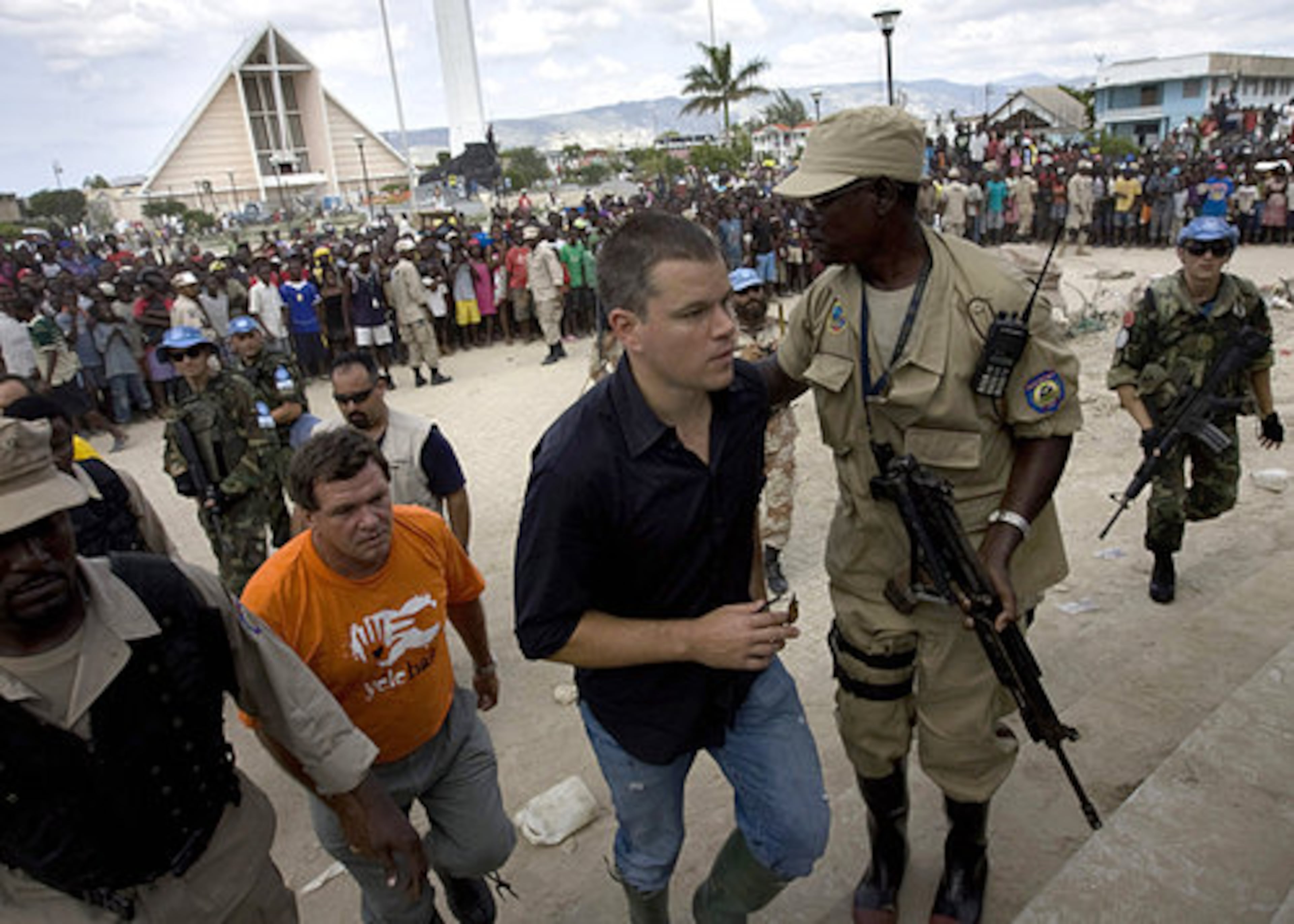 U.S. actor Matt Damon, center, arrives to a food distribution point in Gonaives, Haiti. Damon and Haitian-born singer Wyclef Jean arrived Saturday in Haiti as part of Jean's foundation's Yele Haiti aid activities, after four tropical storms hit the country within one month, leaving 800,000 Haitians in need of aid.