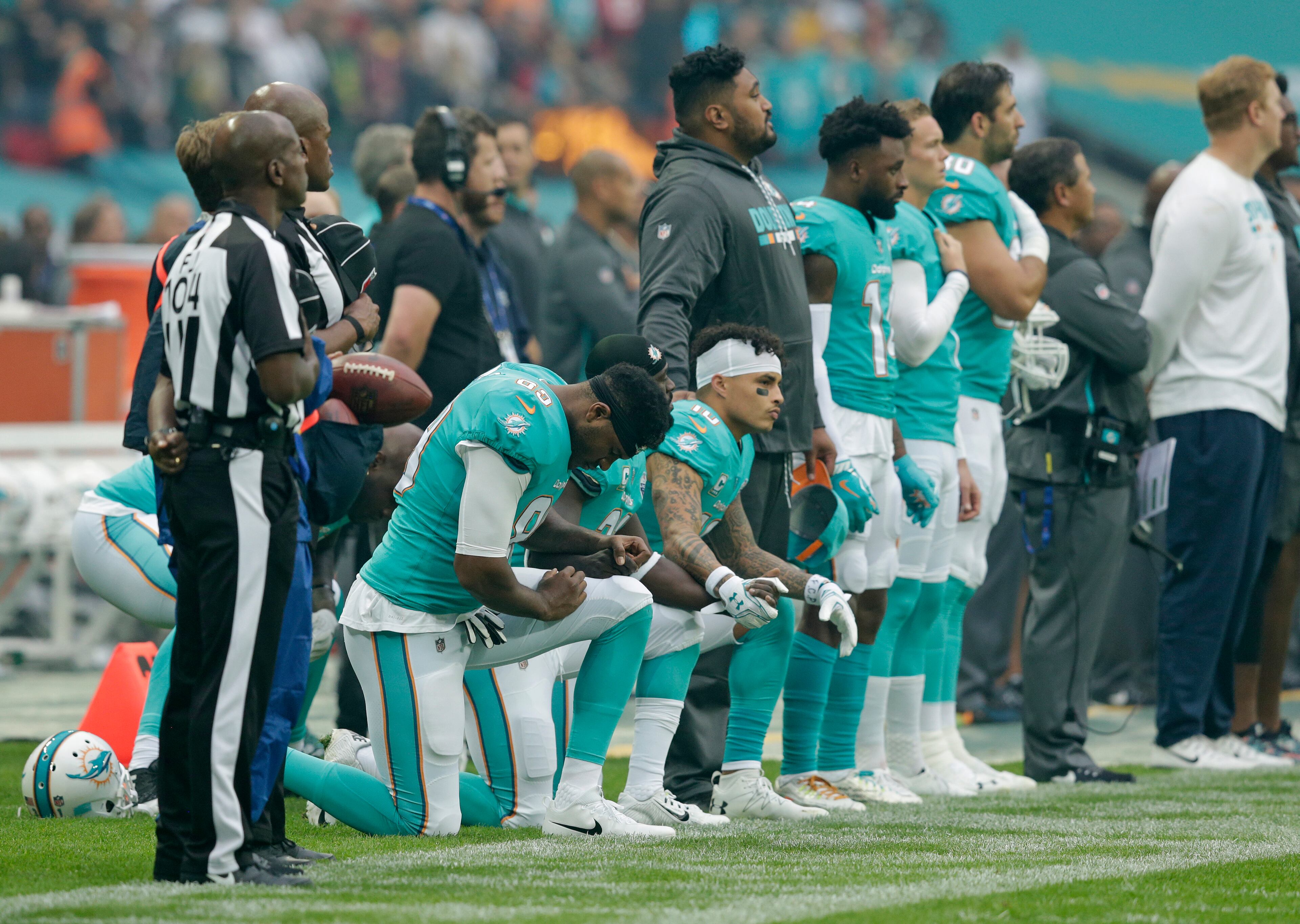 LONDON, ENGLAND - OCTOBER 01: Miami Dolphins players kneel down during the national anthem before the NFL game between the Miami Dolphins and the New Orleans Saints at Wembley Stadium on October 1, 2017 in London, England. (Photo by Henry Browne/Getty Images)