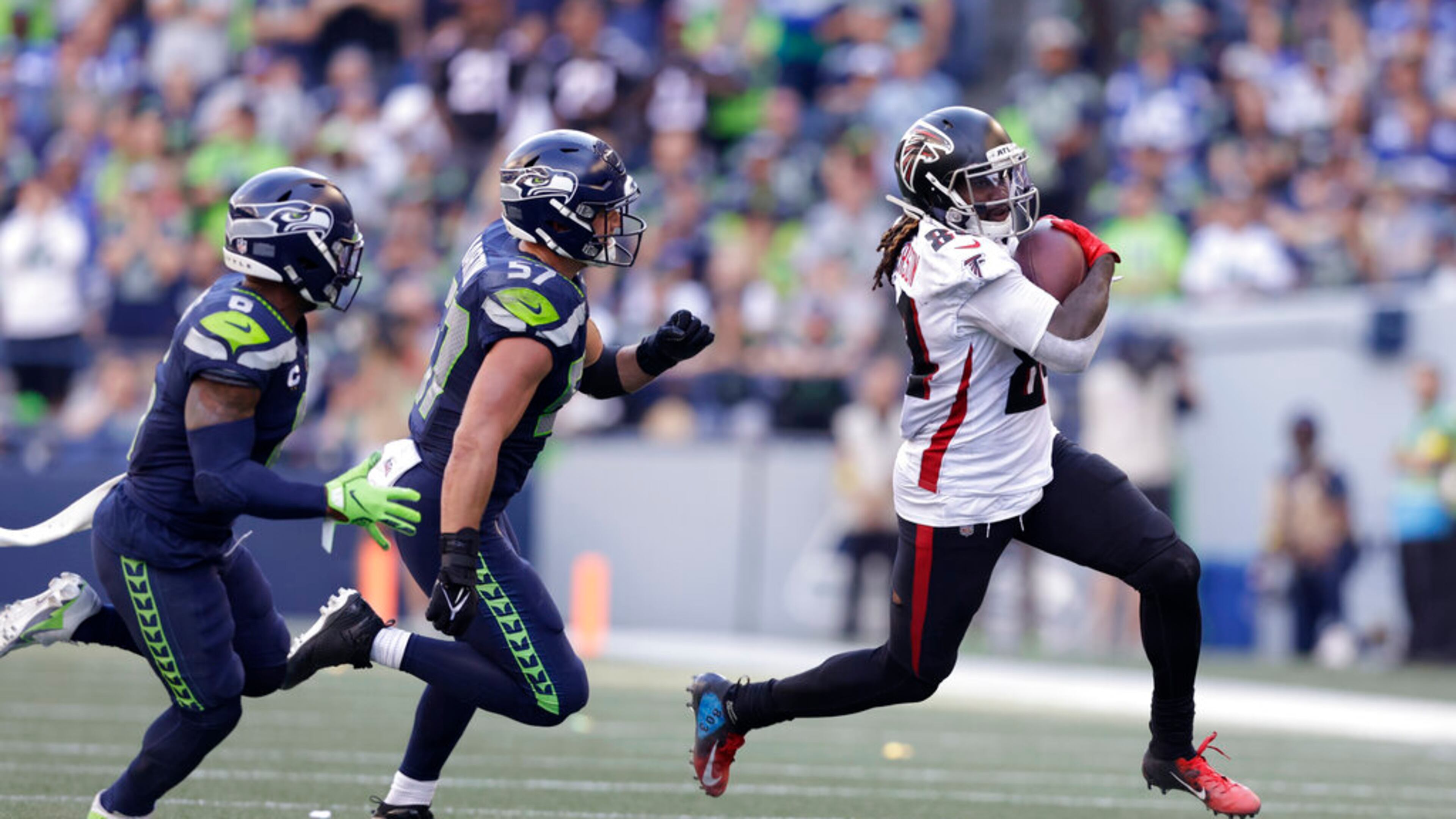 Atlanta Falcons running back Cordarrelle Patterson runs with the ball as Seattle Seahawks safety Quandre Diggs (6) and linebacker Cody Barton (57) chase in an NFL football game, Sunday, Sept. 25, 2022, in Seattle. (AP Photo/ John Froschauer)