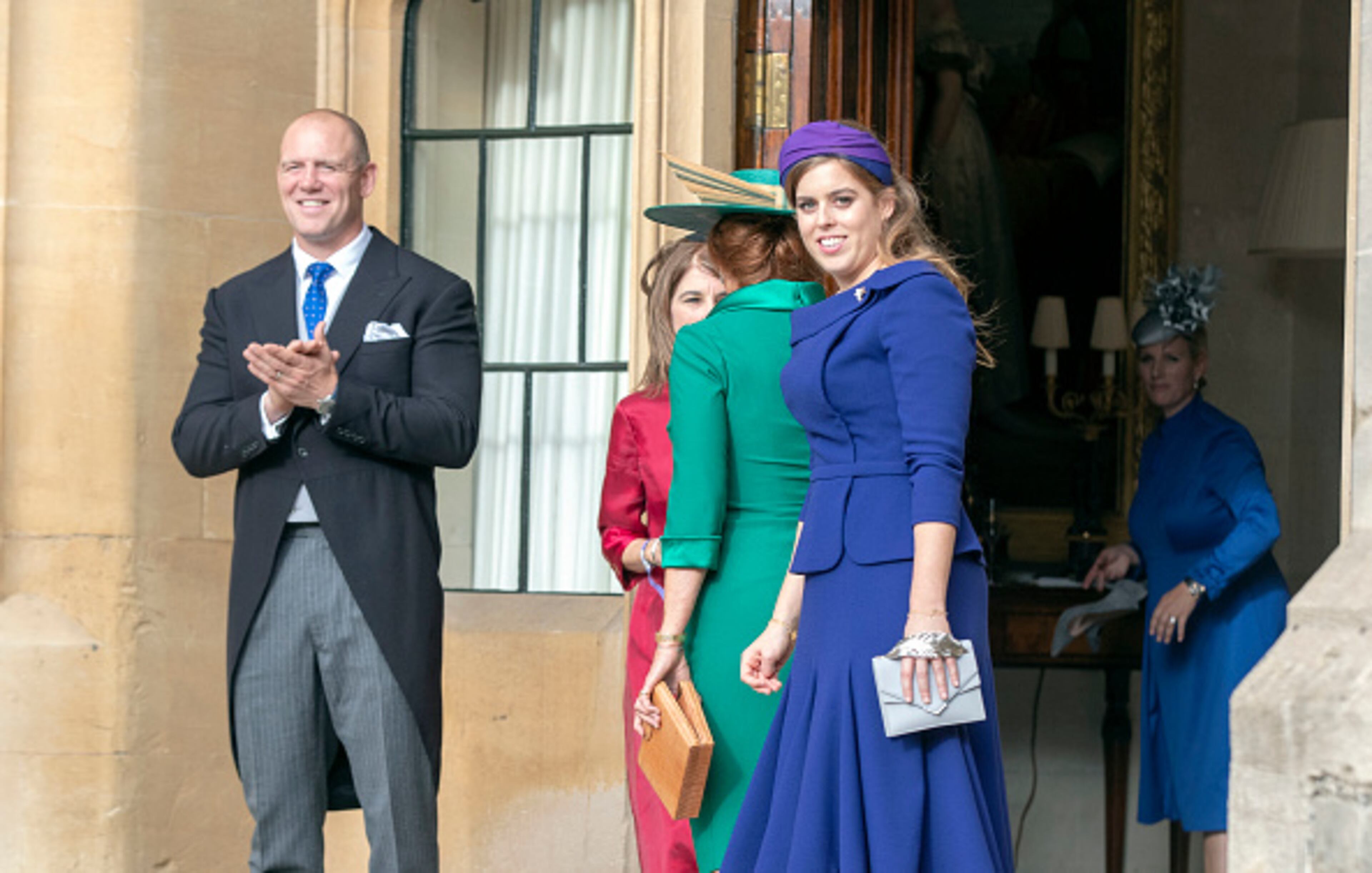 WINDSOR, ENGLAND - OCTOBER 12: Mike Tindall and Princess Beatrice watch as Princess Eugenie and Jack Brooksbank leave Windsor Castle after their wedding for an evening reception at Royal Lodge on October 12, 2018 in Windsor, England. (Photo by Steve Parsons - WPA Pool/Getty Images)