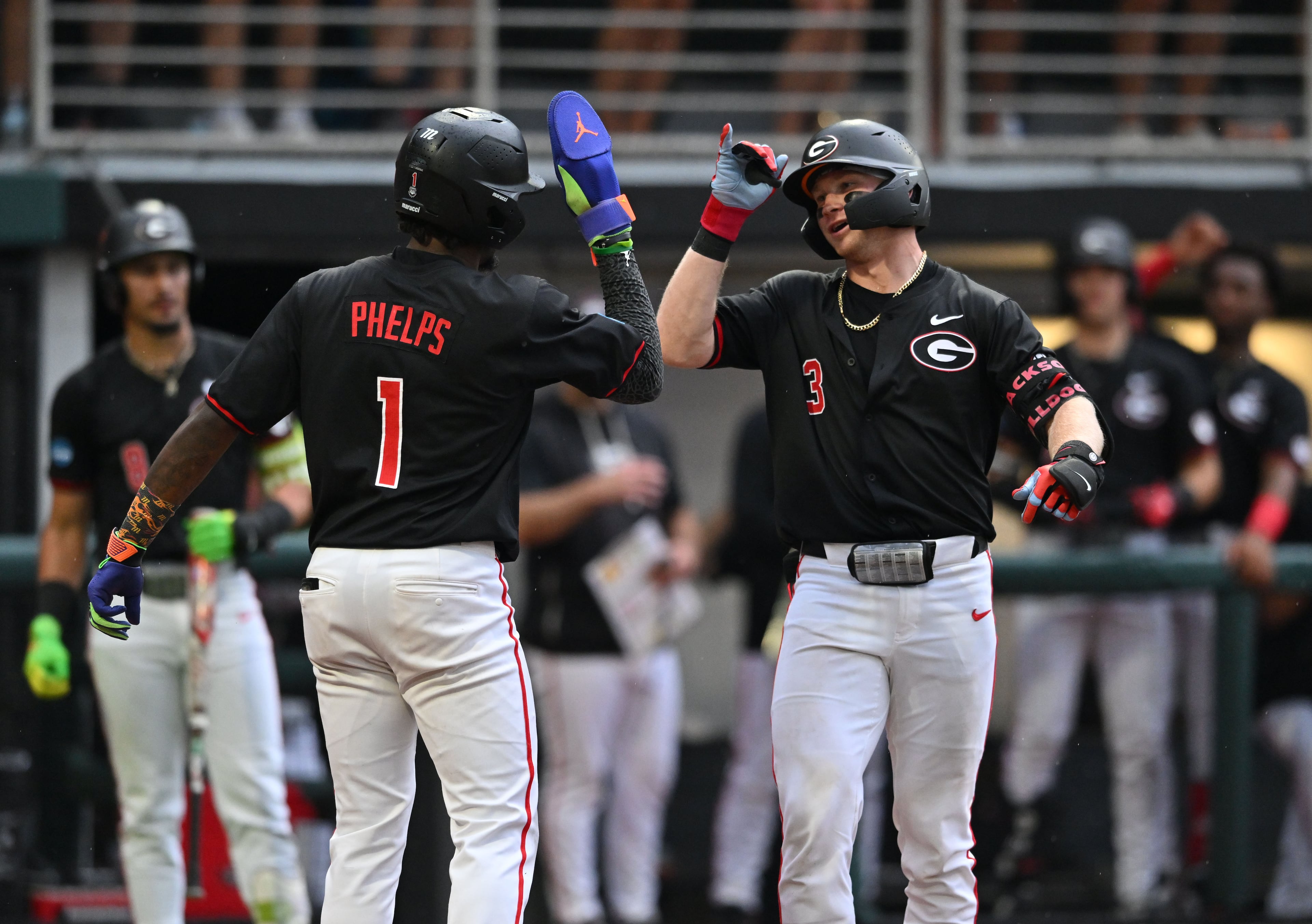 Georgia catcher Daniel Jackson (3) celebrates with Georgia infielder Tre Phelps (1) after hitting a solo home run during the fifth inning of their NCAA Regional game at Foley Field, Friday, May 29, 2026, in Athens. (Hyosub Shin/AJC)