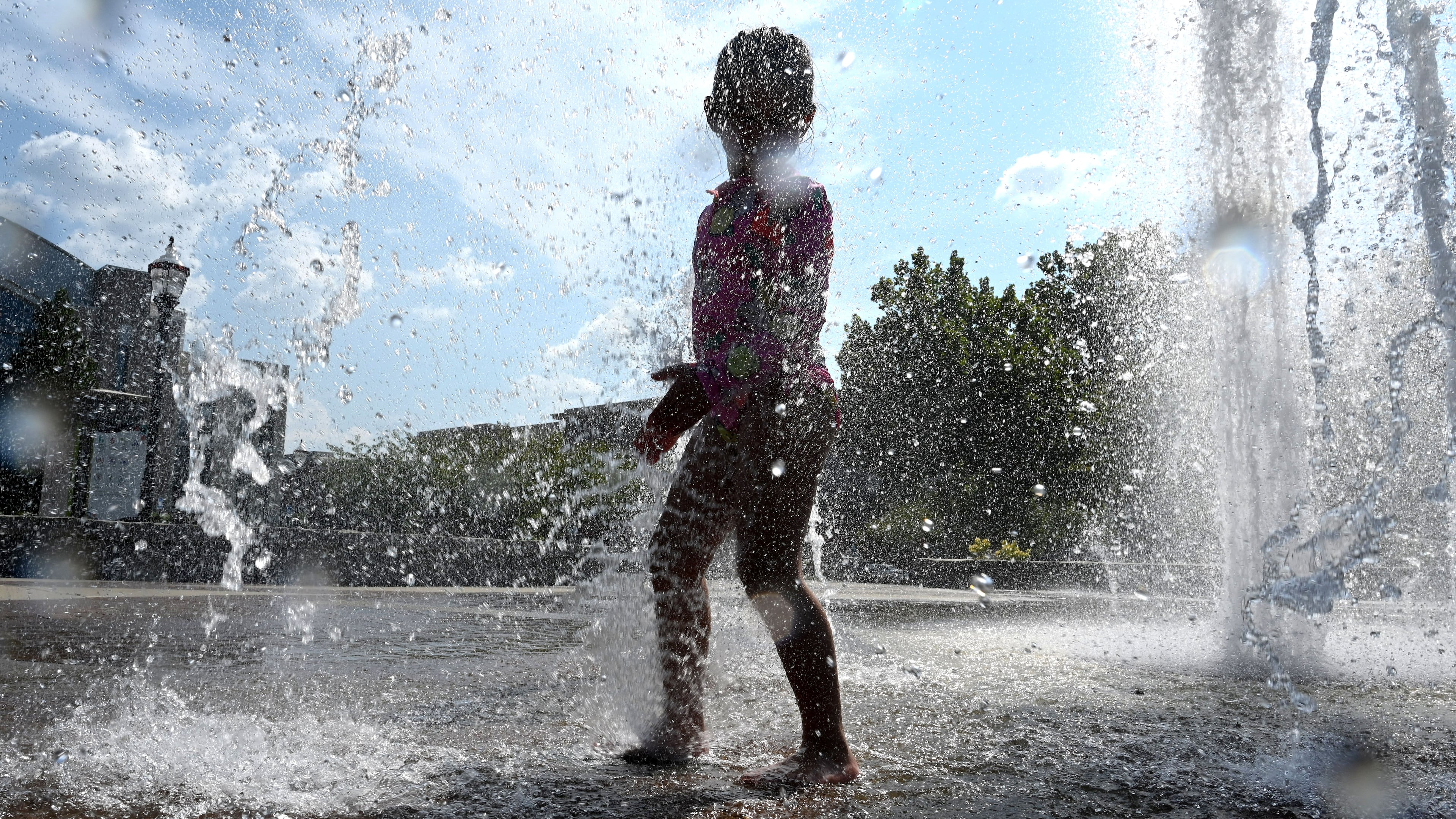 Paulina Lopez, 4, plays in the Big Splash fountain at Town Center Park on Wednesday, Sept. 2, 2026, in Suwanee. The National Weather Service predicts hot and humid conditions for the long Labor Day weekend. (Hyosub Shin/AJC)