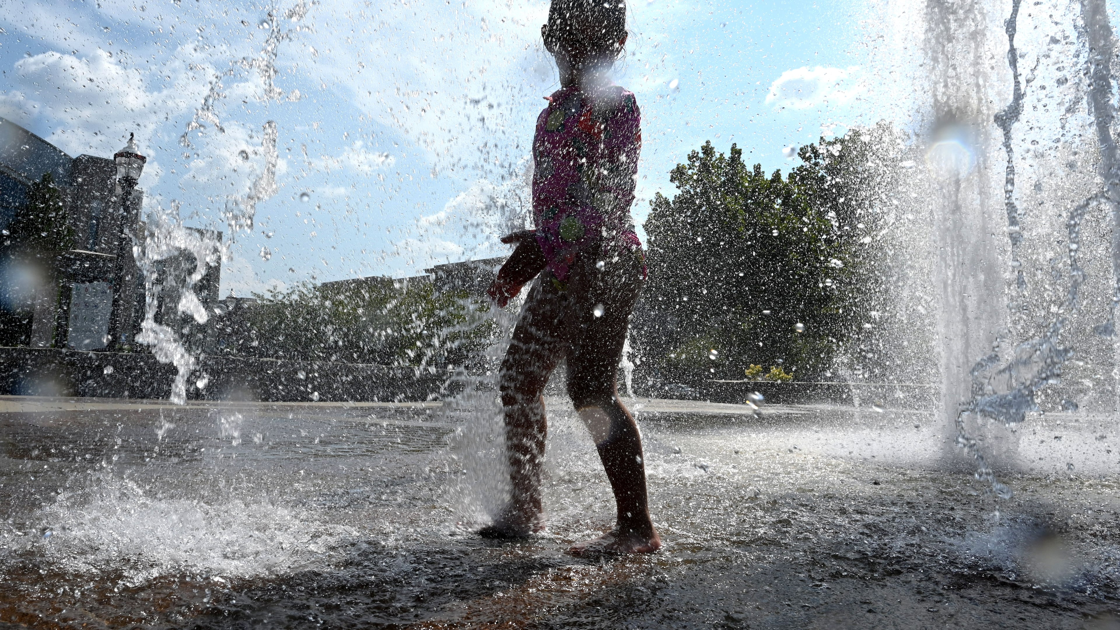 Paulina Lopez, 4, plays in the Big Splash fountain at Town Center Park on Wednesday, Sept. 2, 2026, in Suwanee. The National Weather Service predicts hot and humid conditions for the long Labor Day weekend. (Hyosub Shin/AJC)