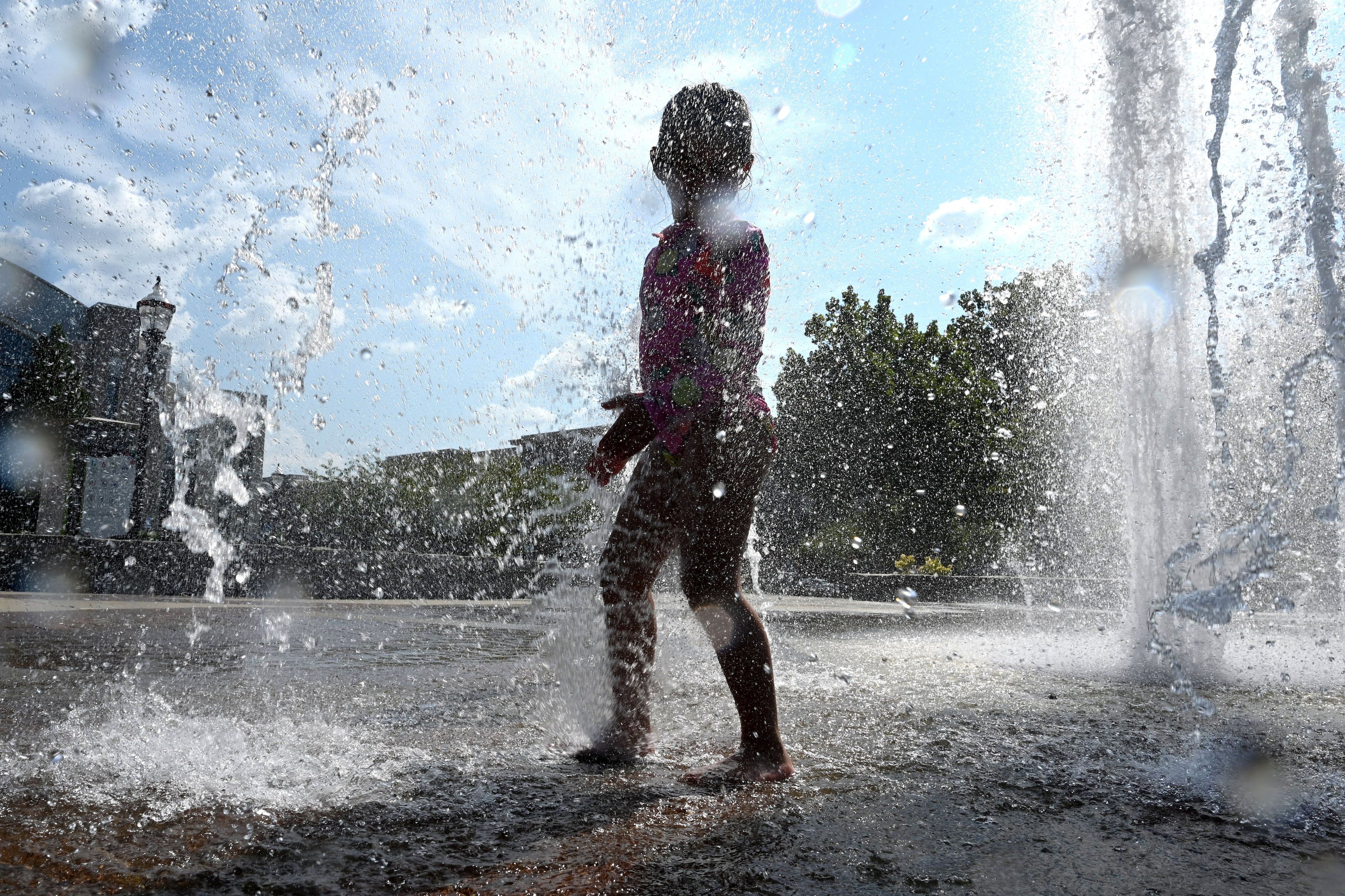 Paulina Lopez, 4, plays in the Big Splash fountain at Town Center Park on Wednesday, Sept. 2, 2026, in Suwanee. The National Weather Service predicts hot and humid conditions for the long Labor Day weekend. (Hyosub Shin/AJC)