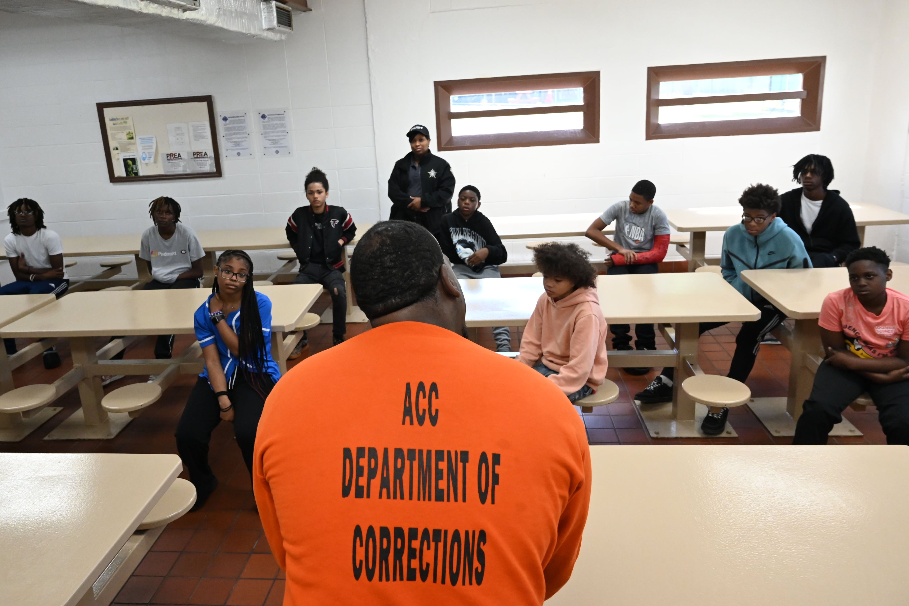 Marcus Lawson (foreground, center), an inmate at the Athens-Clarke County Correctional Institution, speaks to students inside the prison Saturday, May 16, 2026, in Athens. "Don't do to your mama what I did to mine," said Lawson, who was sentenced to 30 years for numerous offenses related to the robbery of taxicab drivers. (Hyosub Shin/AJC)