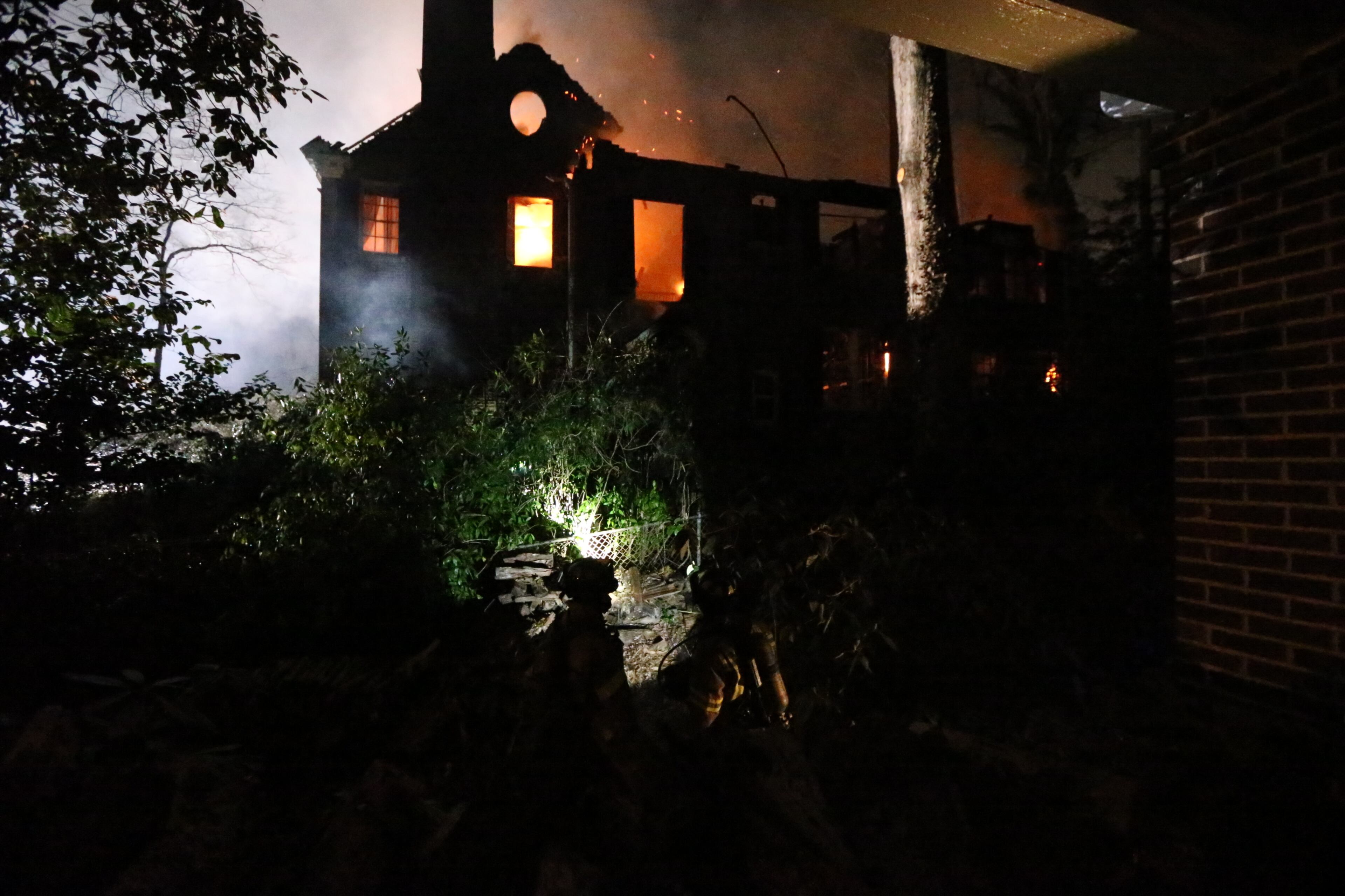 Two firefighters suffered minor injuries battling a Tuesday night blaze that destroyed a large, vacant home in the Druid Hills neighborhood of northeast Atlanta.