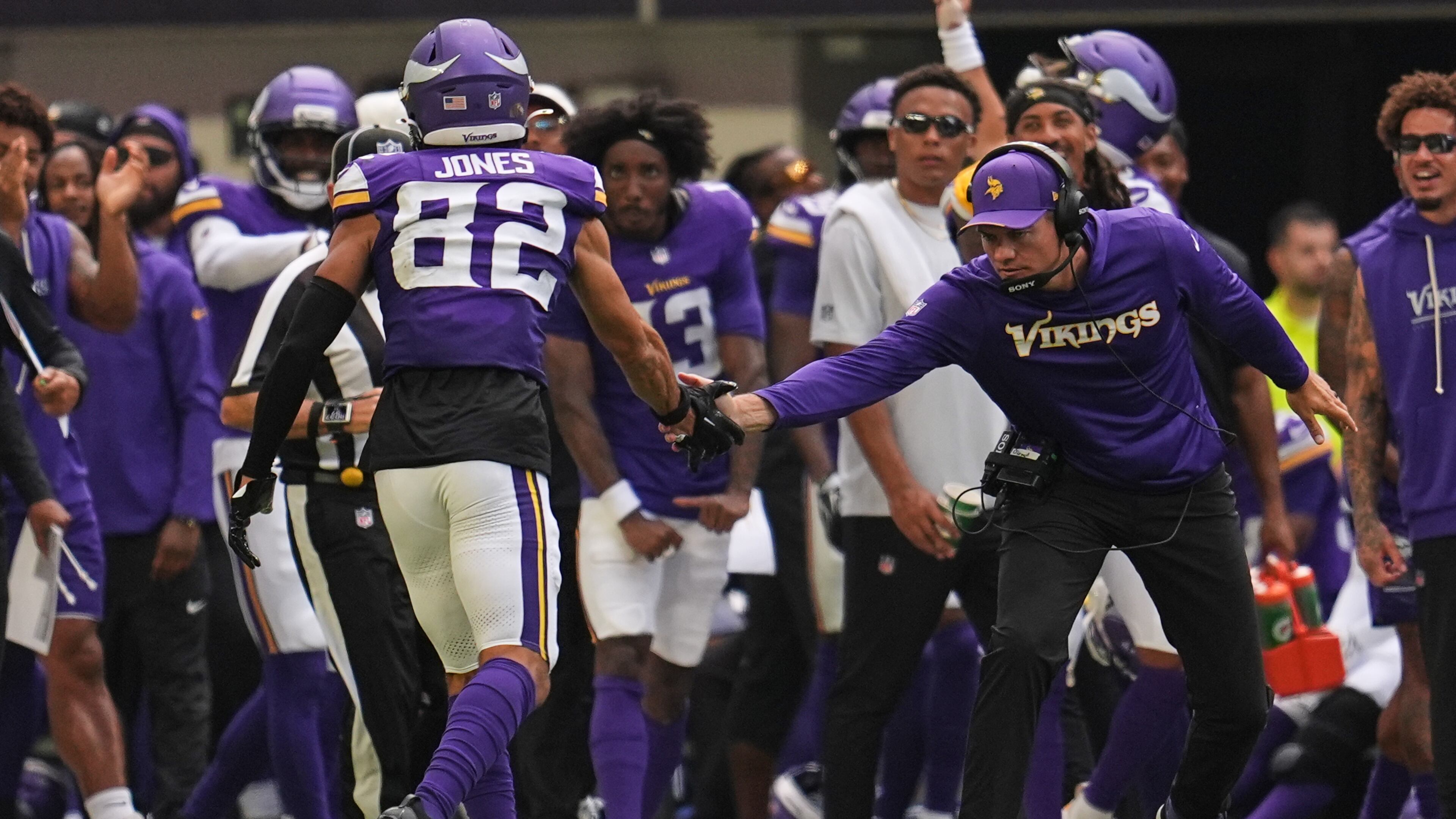 Minnesota Vikings wide receiver Jeshaun Jones (82) celebrates with head coach Kevin O'Connell after completing a 35-yard catch during the first half of an NFL preseason football game against the Baltimore Ravens, Saturday, Aug. 22, 2026, in Minneapolis. (AP Photo/Abbie Parr)