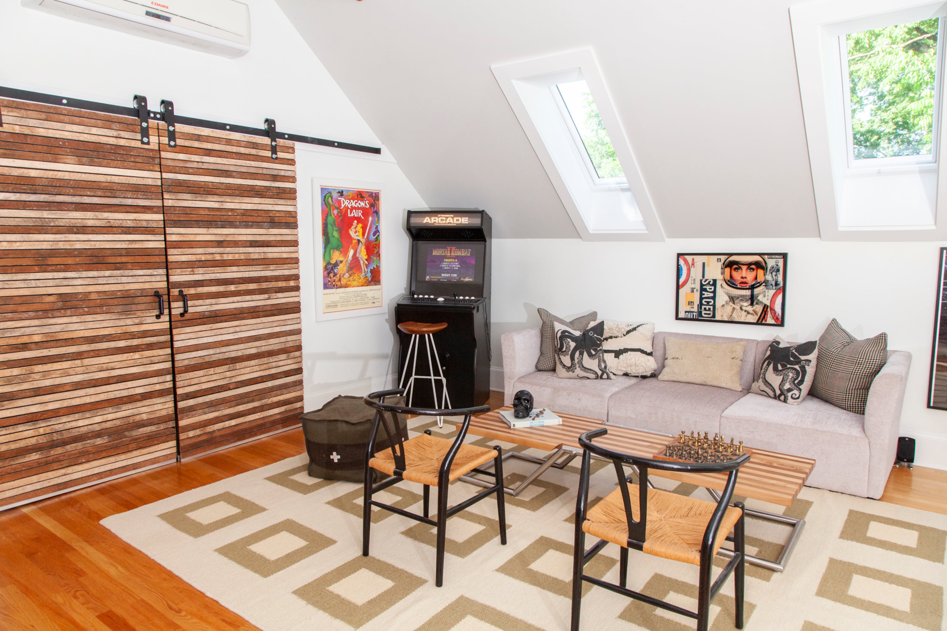 Guests gravitate to the upstairs arcade, which includes a machine built by homeowner Scott Melnick to play old video games.
