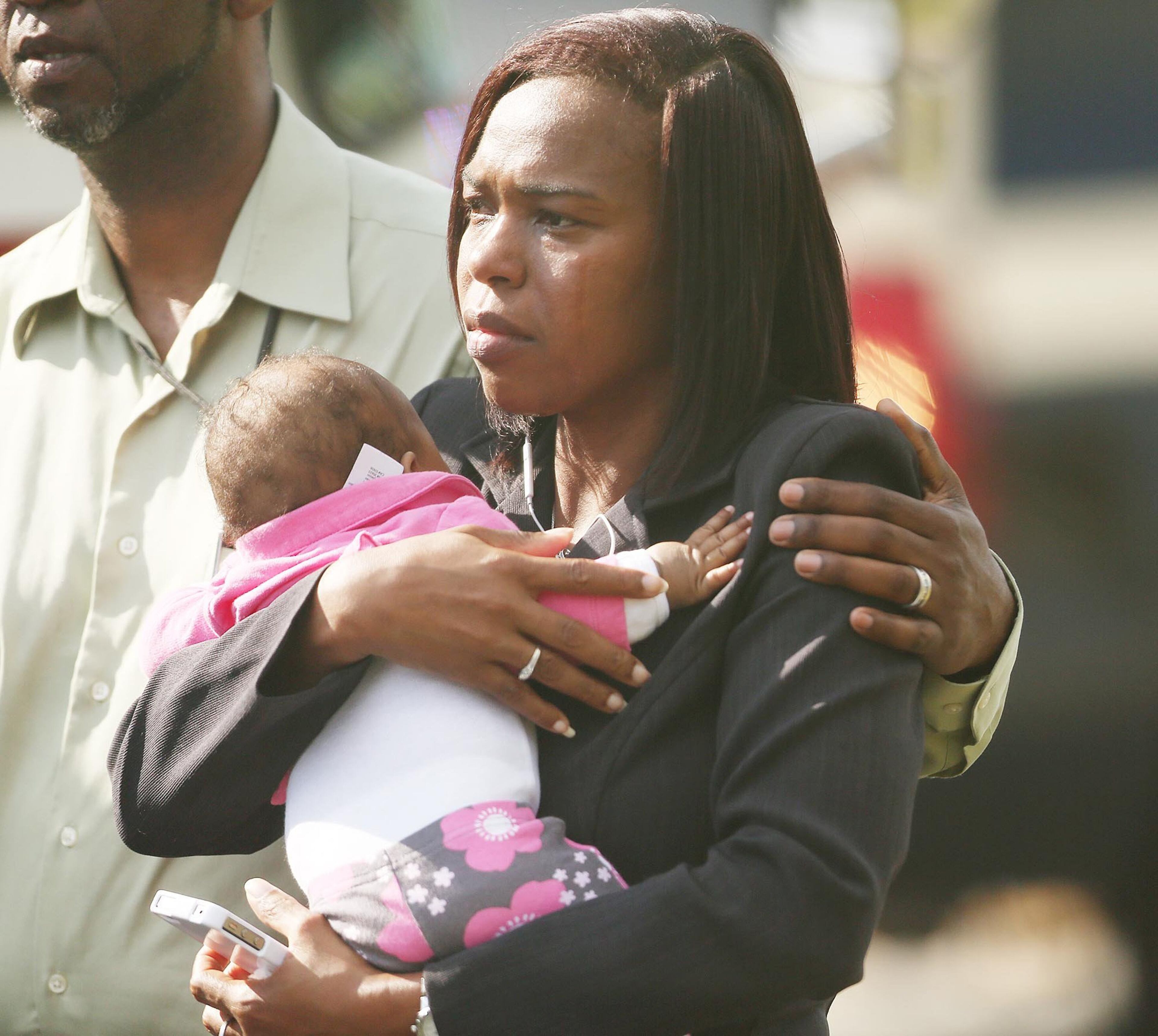 Children are escorted by their parents from the KinderCare Learning Center in Winter Park, Fla. (Stephen M. Dowell, Orlando Sentinel/MCT)