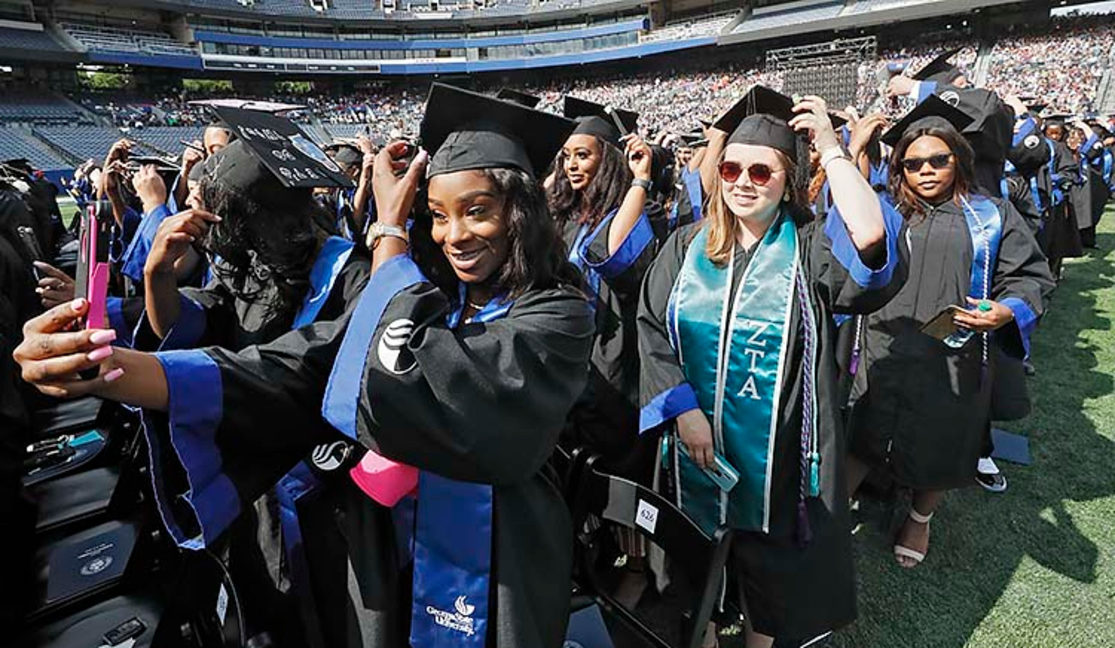 May 9, 2019 - Atlanta - Graduates move their tassels as their degrees are conferred. Georgia State University is hosting its 104th Commencement Monday, May 6 through Tuesday, May 14 at Panther Stadium in Atlanta. Six schools held their graduation on Thursday. Bob Andres / bandres@ajc.com