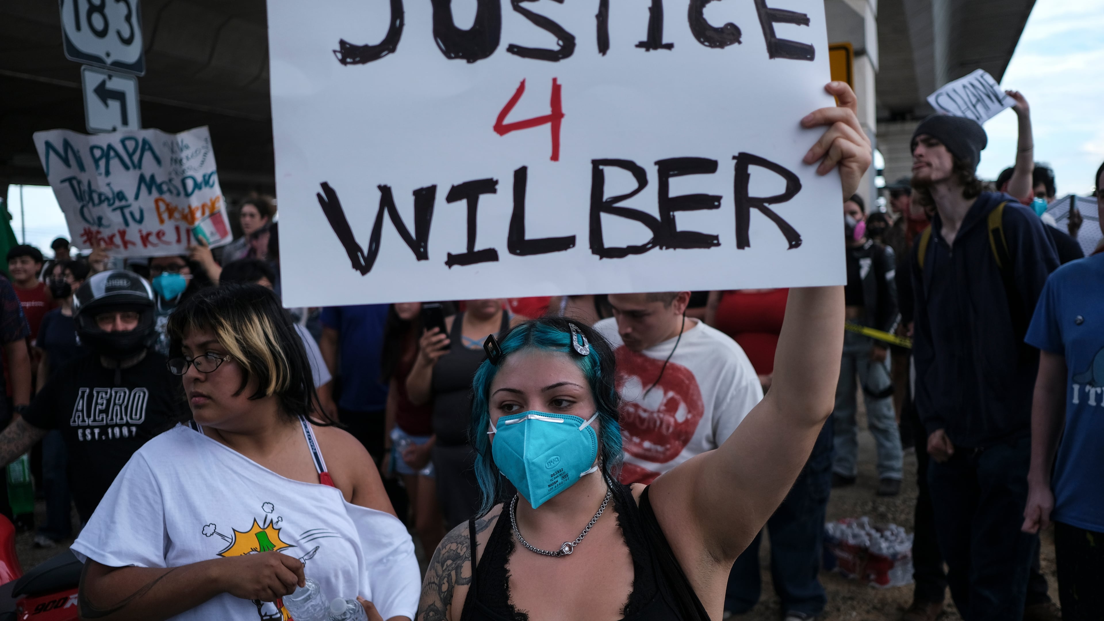 People speak during a demonstration where a man was shot in his vehicle by an ICE officer, Sunday, Sept. 20, 2026, in Austin, Texas. (AP Photo/Joel Angel Juarez)