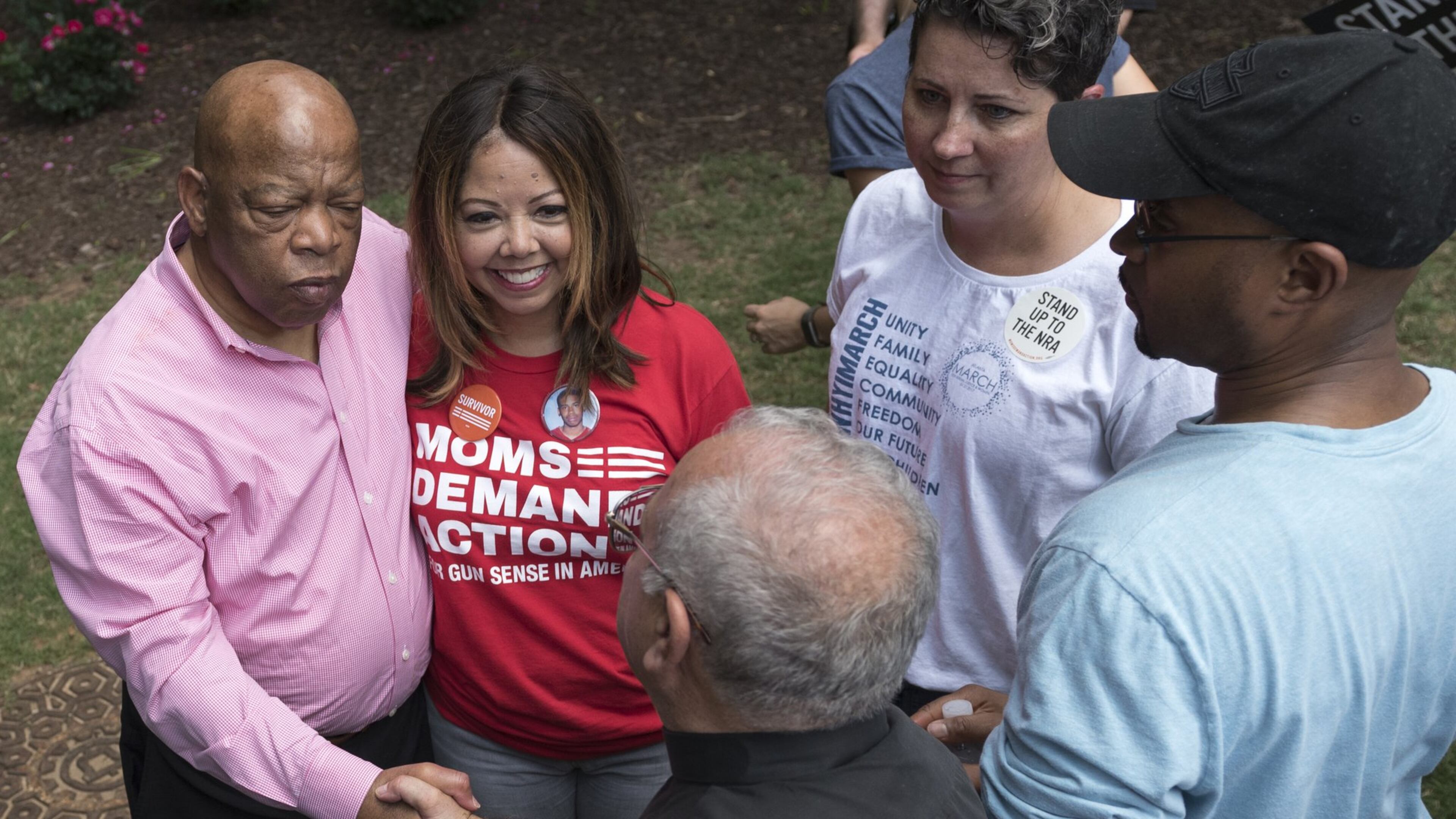 U.S. Rep. John Lewis stands with Lucy McBath, then a national spokeswoman for Moms Demand Action for Gun Sense in America, as they greet rally attendees at Woodruff Park in Atlanta in 2017. Tuesday, McBath won the Democratic nominatin in the 6th Congressional District. (DAVID BARNES / DAVID.BARNES@AJC.COM)