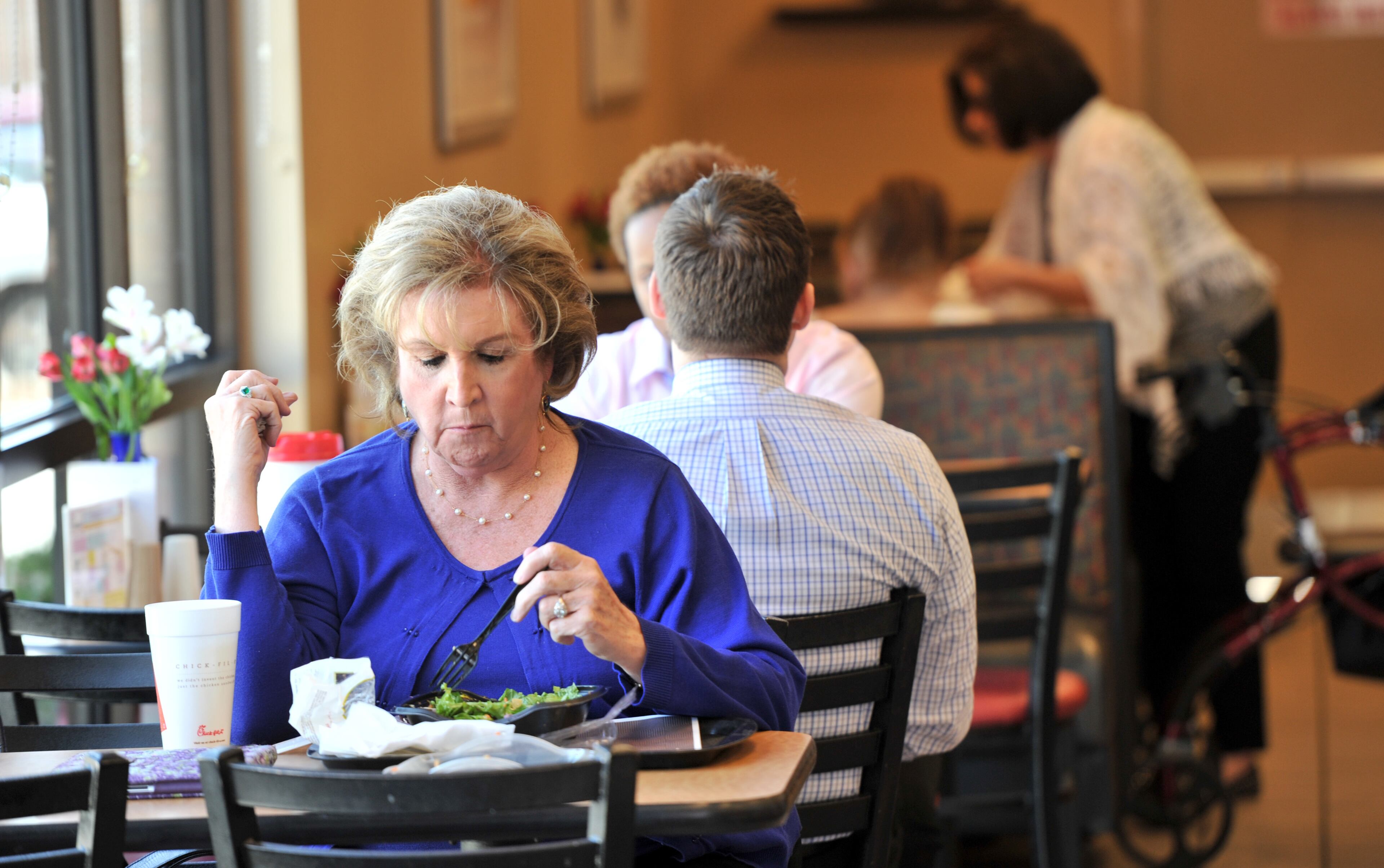 Christie Fenton, of Dunwoody, eats at a Chick-fil-A on Tuesday, April 1, 2014. Chick-fil-A has surpassed KFC as America's number one purveyor of fried chicken with sales greater $5 billion with a fraction of the stores fronted by the Colonel. HYOSUB SHIN / HSHIN@AJC.COM