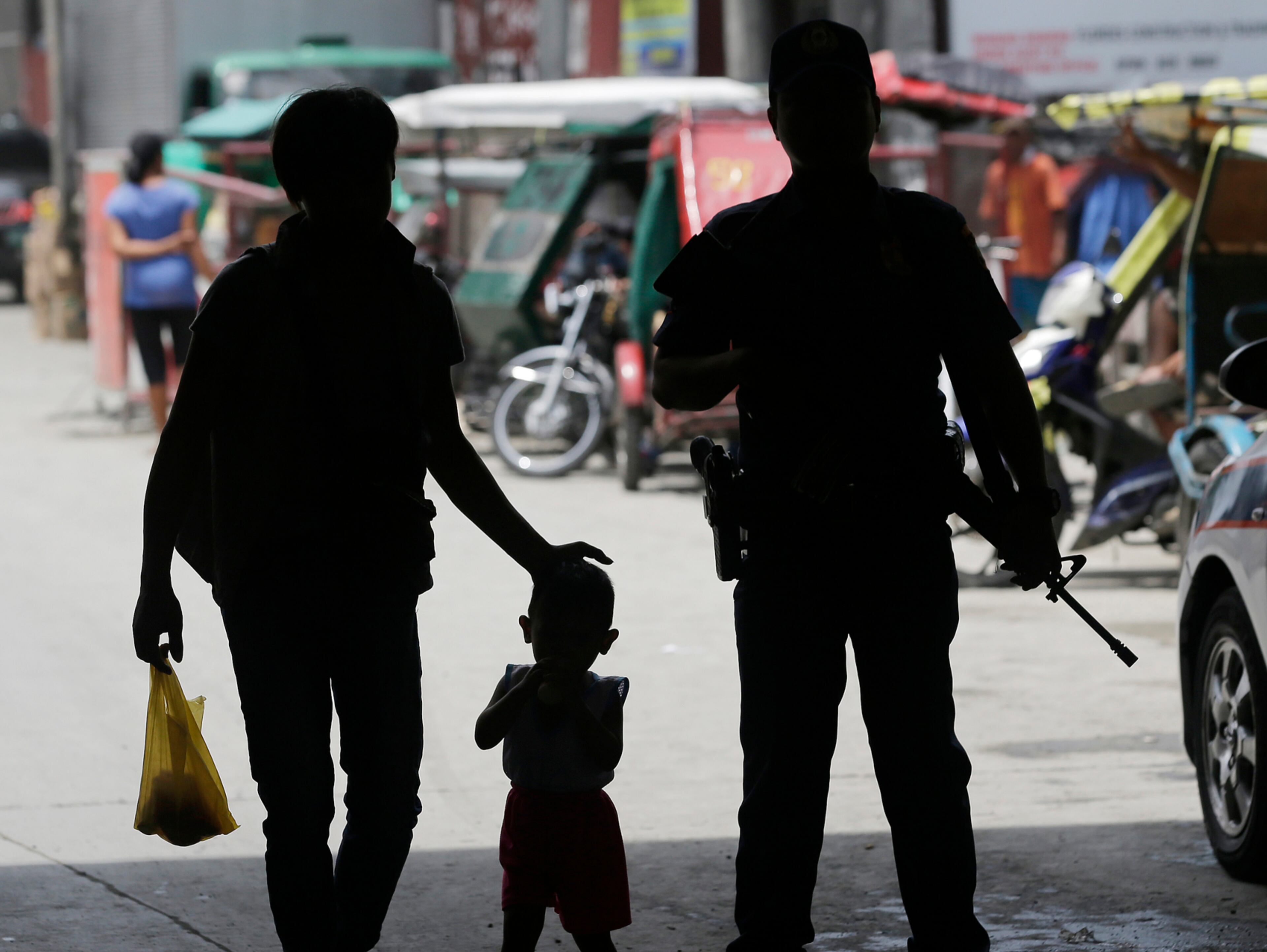 A policeman stands at a checkpoint in Manila, Philippines, Wednesday, May 24, 2017 as the Philippine National Police is placed under full alert status following the declaration of martial law in Mindanao southern Philippines. Philippine President Rodrigo Duterte warned Wednesday that he'll be harsh in enforcing martial law in his country's south as he abruptly left Moscow to deal with a crisis at home sparked by a Muslim extremist siege on a city, where militants burned buildings overnight and are feared to have taken hostages. (AP Photo/Aaron Favila)