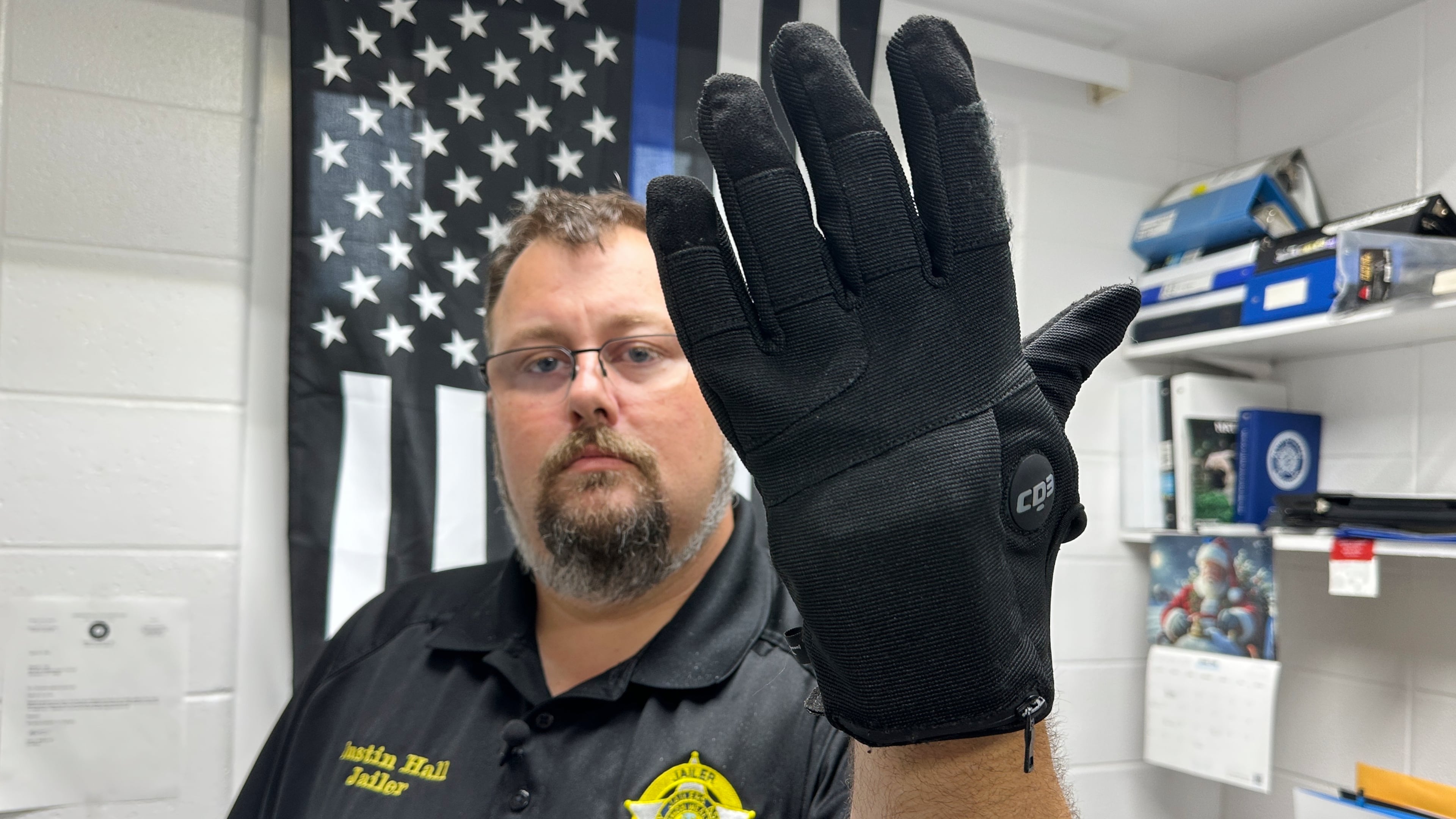 Nelson County, Ky., jailer Justin Hall shows an electric shock glove that is used at his facility, Thursday, Aug. 13, 2026, in Bardstown, Ky. (AP Photo/Dylan Lovan)