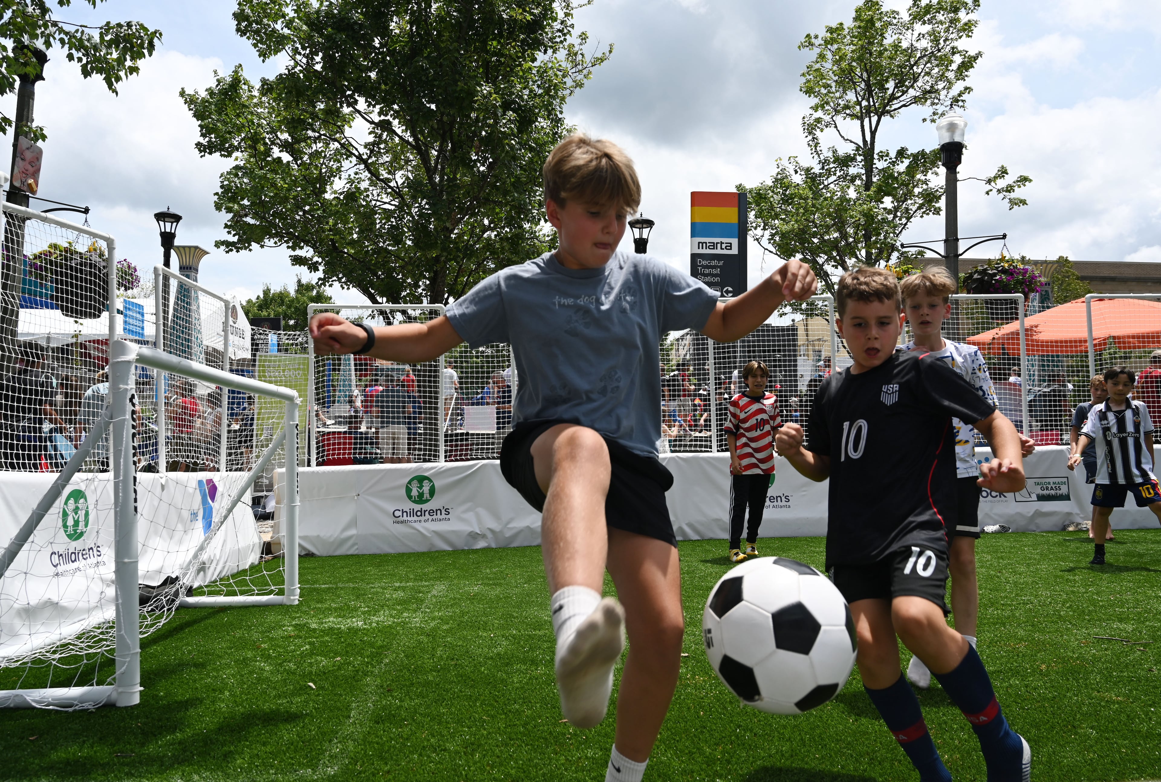 Children play mini-soccer before the USA vs. Australia game during Decatur WatchFest at Decatur Square on Friday, June 19, 2026. (Hyosub Shin/AJC)