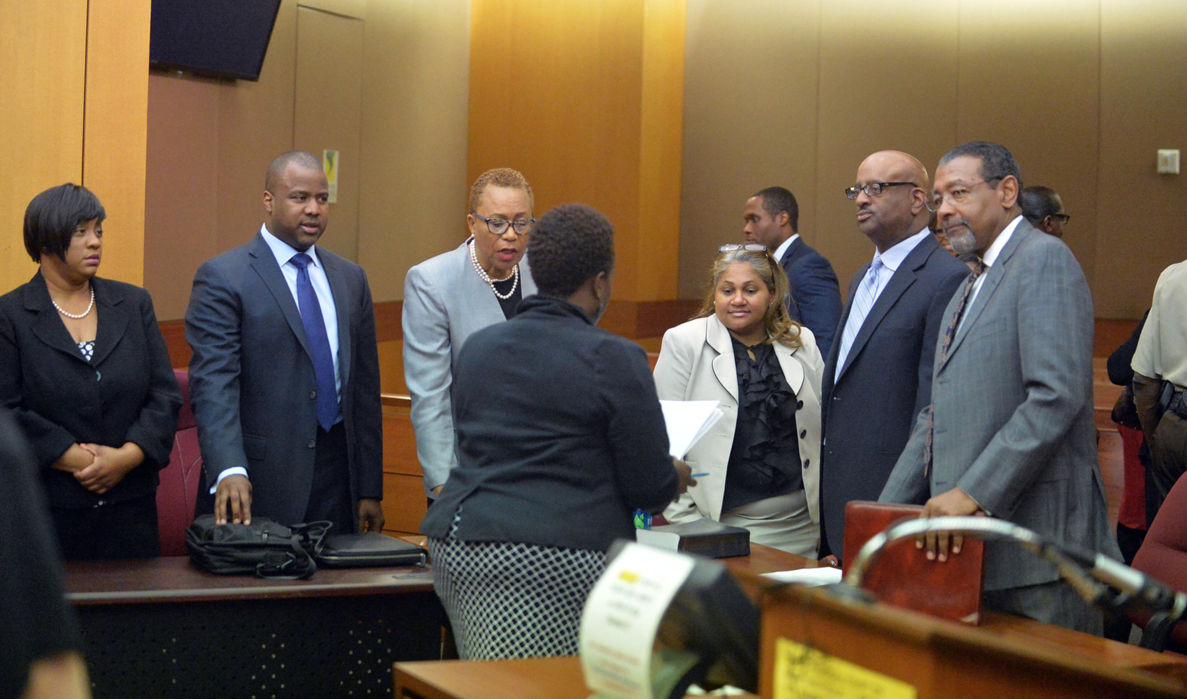 DEFENDANTS RESENTENCED--APRIL 30, 2015 ATLANTA Former Atlanta Public Schools regional directors Tamara Cotman, Sharon Davis-Williams and Michael Pitts and their attorneys talk with a court official following resentencing. Fulton County Superior Court Judge Jerry Baxter holds a resentencing hearing in Fulton County Superior Court, Thursday, April 30, 2015. Former regional directors Tamara Cotman, Sharon Davis-Williams and Michael Pitts were originally given the heftiest punishment - 20 years, seven years to be served in prison and 13 years on probation following their convictions racketeering and other charges in the Atlanta Public Schools test-cheating trial. Fulton County Superior Court Judge Jerry Baxter resentenced the trio to 3 years in prison, 7 years probation, $10,000 fine and 2000 hours of community service. (Atlanta Journal-Constitution, Kent D. Johnson, Pool)