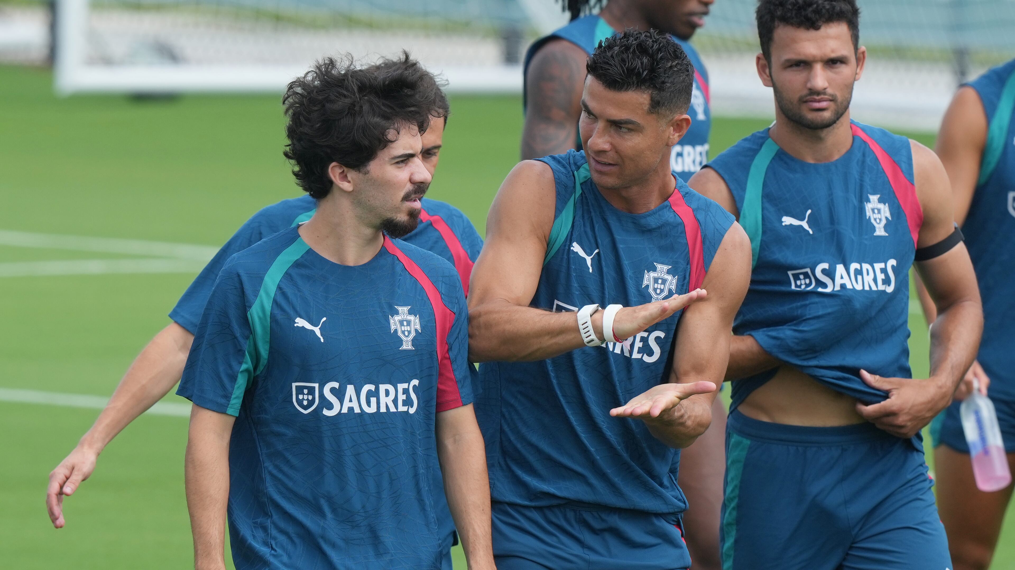 Portugal's Cristiano Ronaldo, center talks to Vitinha during the men's national soccer team World Cup training session Thursday, June 25, 2026, in Palm Beach Gardens, Fla. (AP Photo/Marta Lavandier)