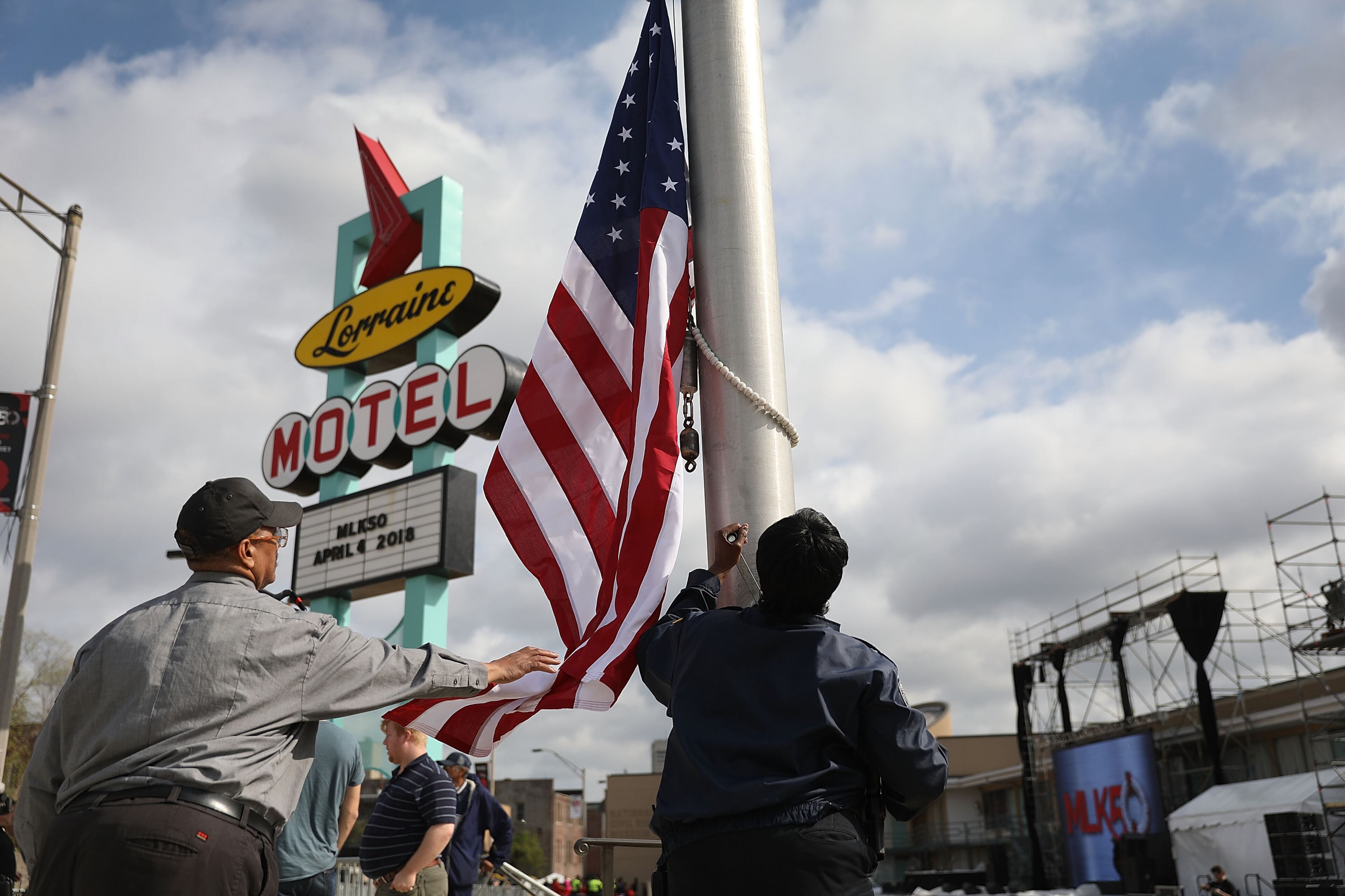 MEMPHIS, TN - APRIL 03: Danny Williams (L) helps raise the American flag at the Lorraine Motel where Dr. Martin Luther King, Jr. was assassinated almost 50 years ago April 3, 2018 in Memphis, Tennessee. The motel, now part of the complex of the National Civil Rights Museum, is commemorating the 50th anniversary of King's assassination on April 4, 1968. (Photo by Joe Raedle/Getty Images)
