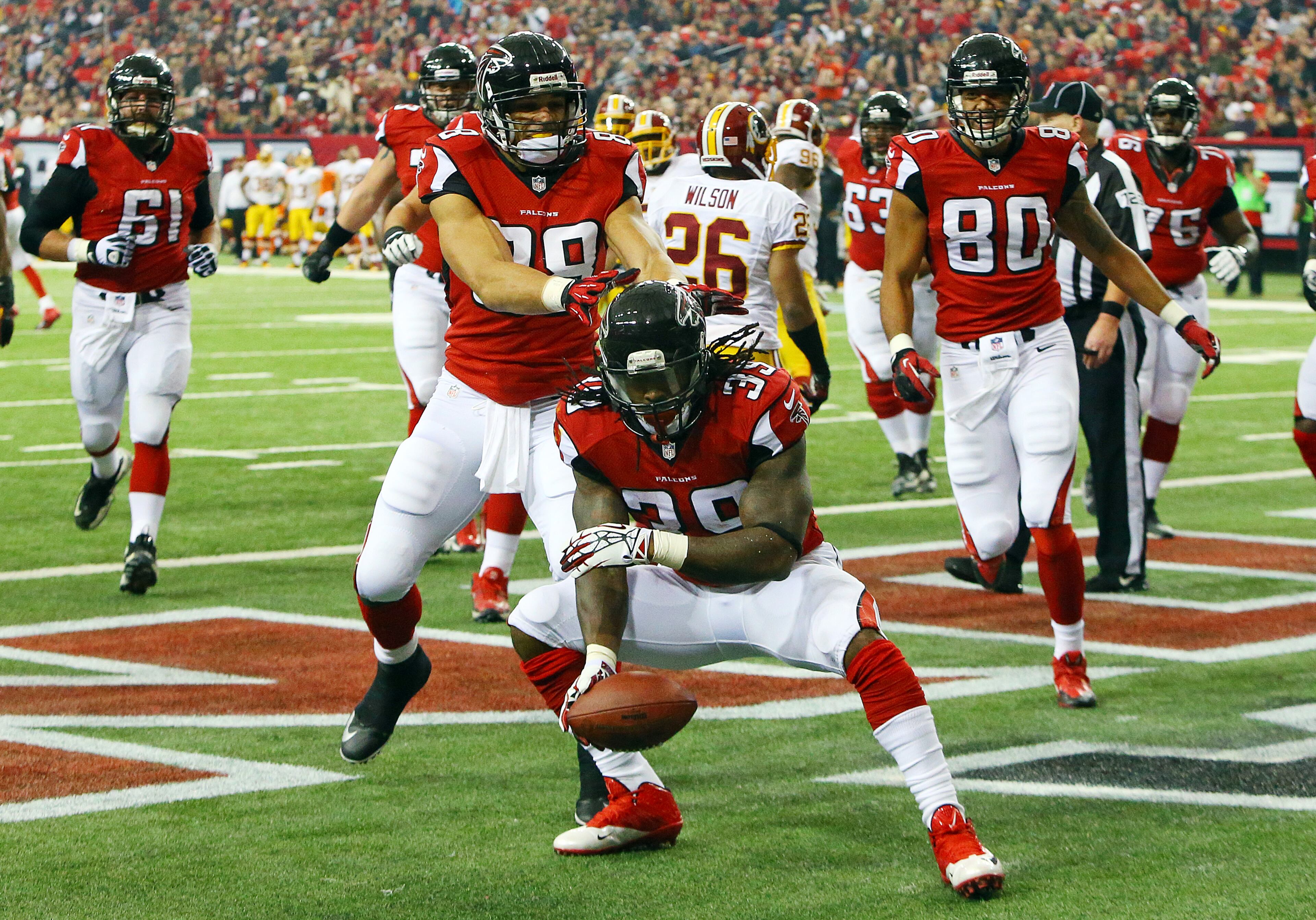 Falcons running back Steven Jackson celebrates his touchdown run against the Redskins with tight end Tony Gonzalez for a 7-0 lead during 1st half action in a NFL football game on Sunday, Dec. 15, 2013, in Atlanta.