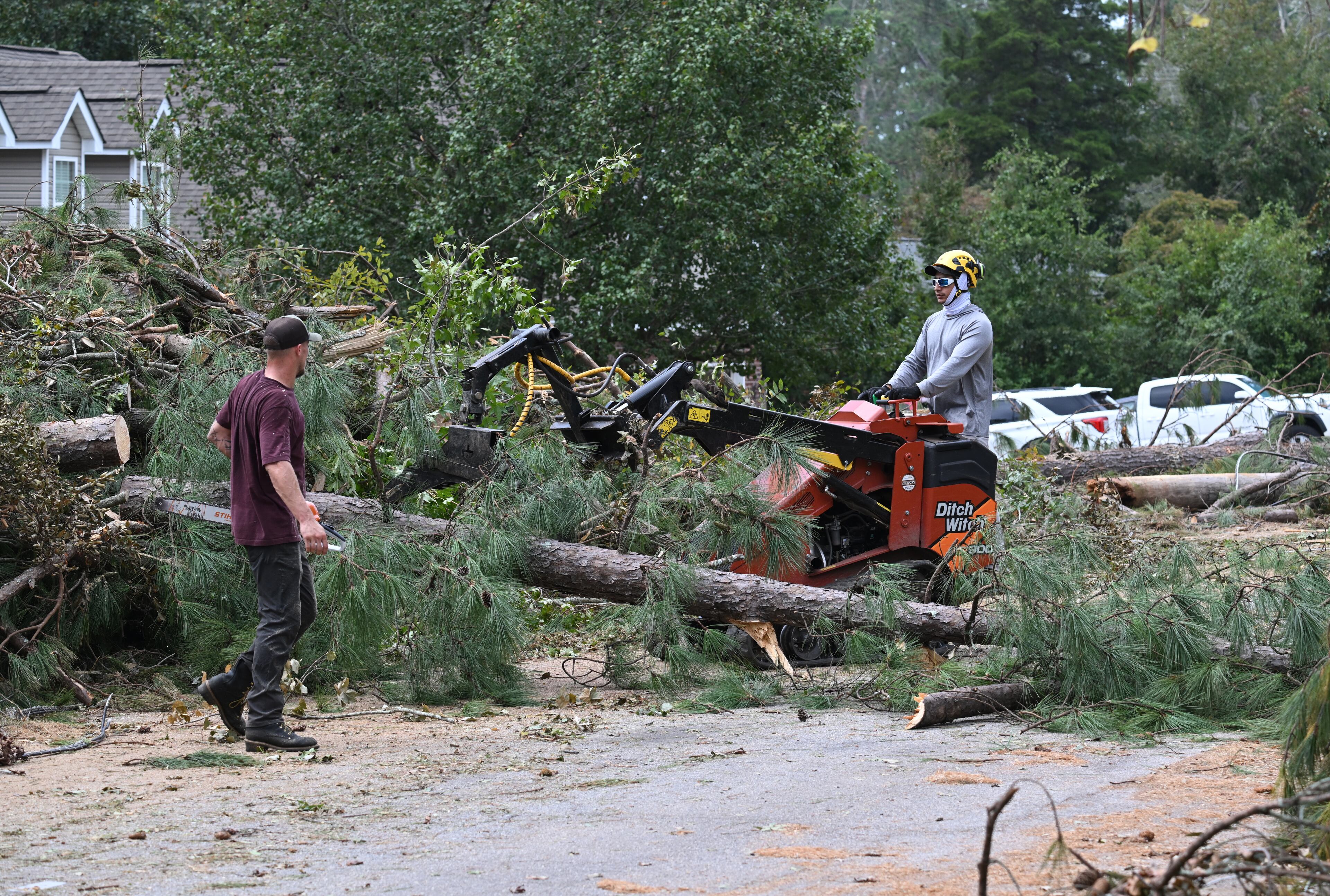 Crew clear trees and debris in the aftermath of Hurricane Helene, Friday, October 4, 2024, in Evans. (Hyosub Shin / AJC)