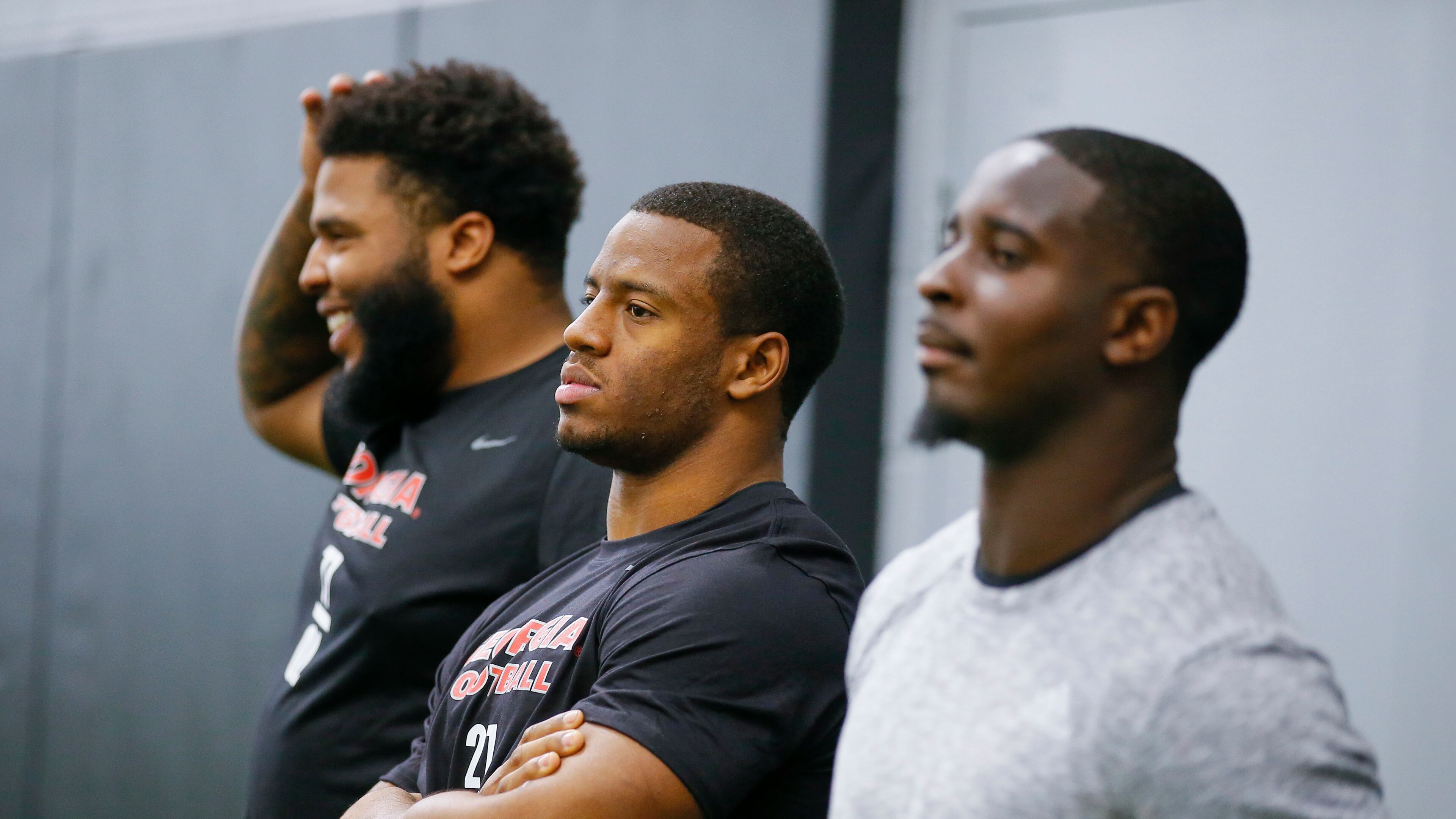 Georgia running back Nick Chubb, center, watches on alongside offensive lineman Isaiah Wynn and running back Sony Michel, right, during Georgia Pro Day, Wednesday, March 21, 2018, in Athens. Pro Day is intended to showcase talent to NFL scouts for the upcoming draft. (AP Photo/Todd Kirkland)