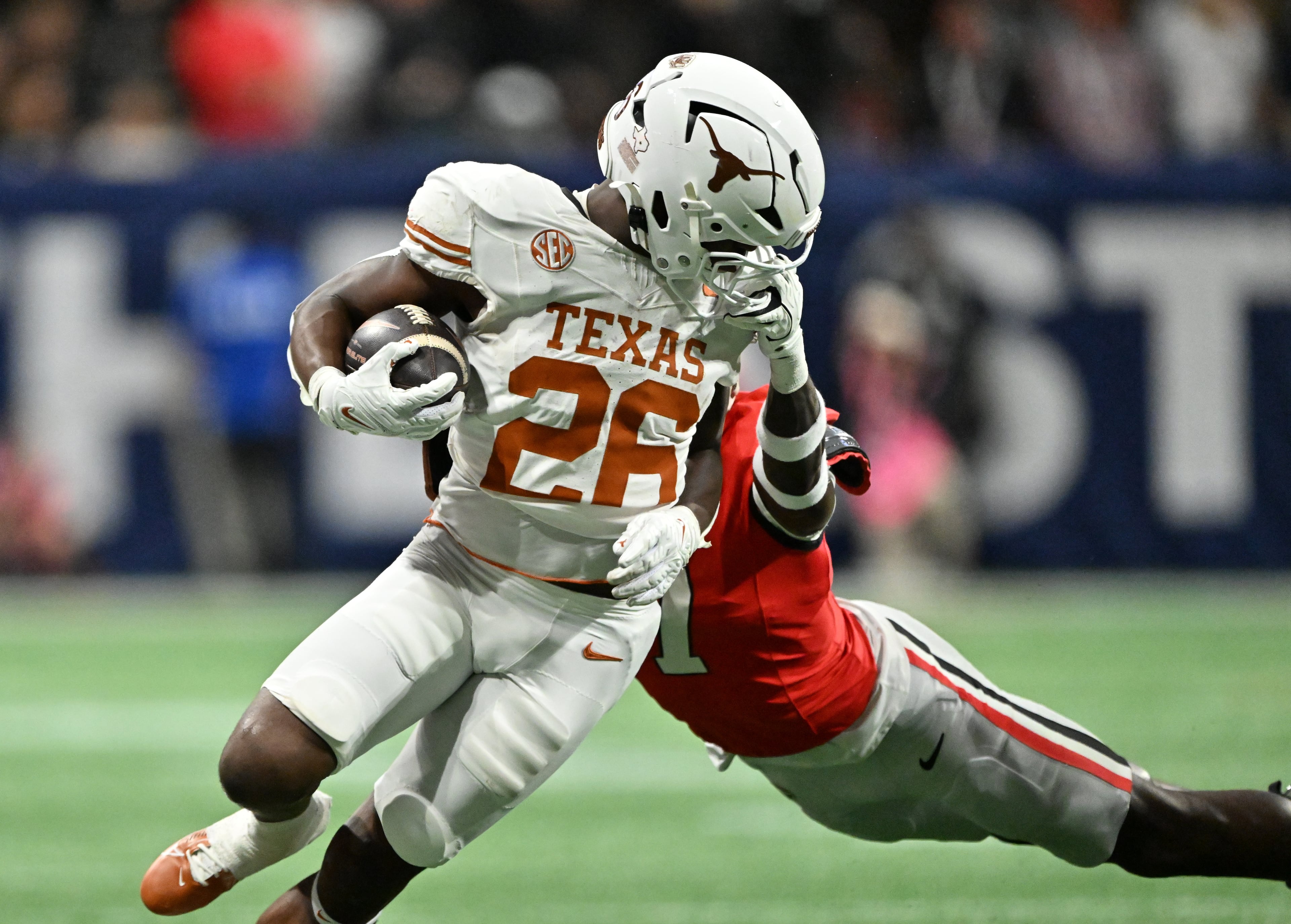 Texas running back Quintrevion Wisner (26) gets tackled by *Georgia tight end Lawson Luckie (7) during the SEC Championship football game at the Mercedes-Benz Stadium, Saturday, December 7, 2024, in Atlanta. (Hyosub Shin / AJC)