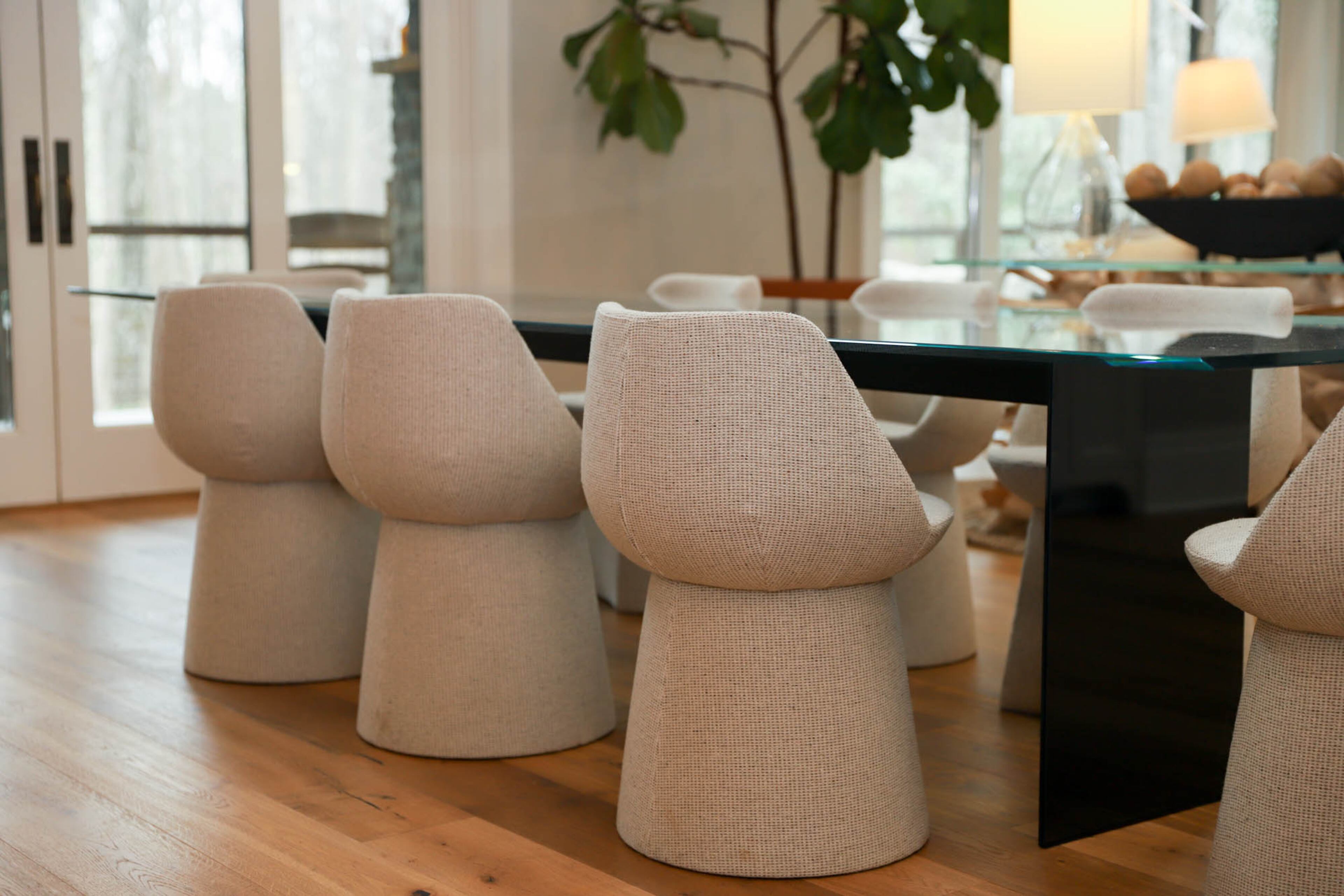 The Ruths kept the modern Gallotti & Radice glass table from their old house but softened the look by switching the chairs with upholstered seating.