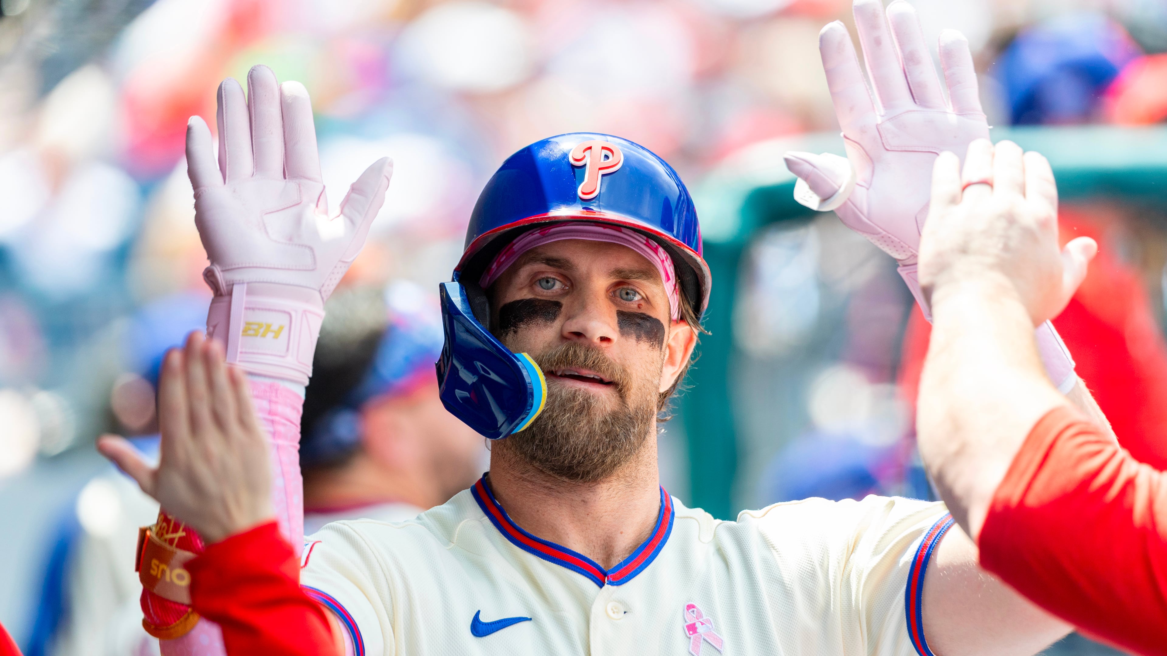 Philadelphia Phillies' Bryce Harper is congratulated in the dugout after he hit a solo home run in the first inning of a baseball game against the Colorado Rockies, Sunday, May 10, 2026, in Philadelphia. (AP Photo/Laurence Kesterson)