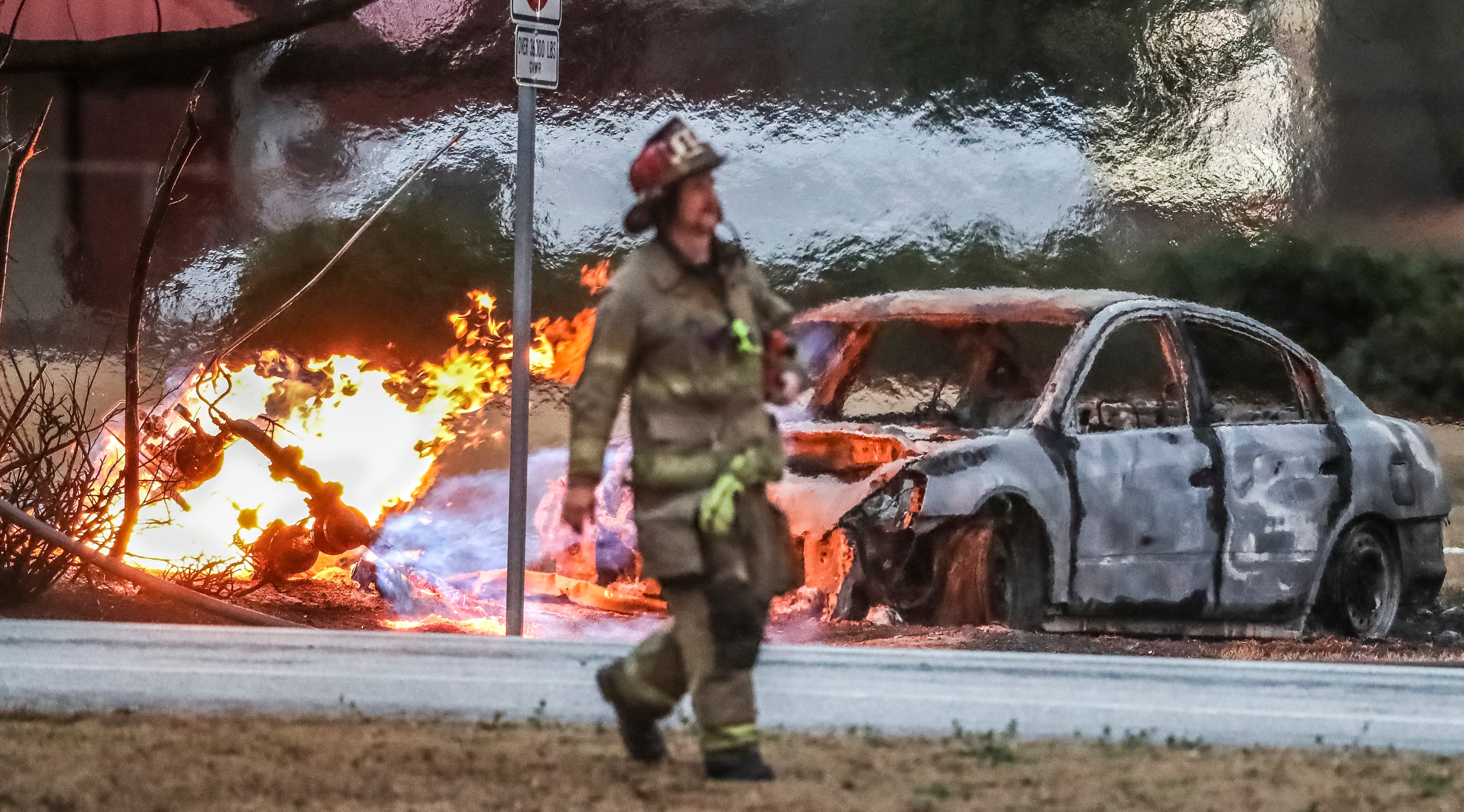 Heat waves leave a mirage effect over a burning gas line that ruptured after a police chase through Gwinnett County, Georgia outside of Atlanta that ended in a fiery crash early Friday, Feb. 8, 2019. The crash cut power along Grayson highway in Lawrenceville. Grayson Highway at Simonton Road was shut down for nearly six hours while authorities worked to get the fire under control. While power was restored by 6 a.m., the car was on fire until about 8:30 a.m., when utility crews shut off the gas that was feeding the flames. The road reopened shortly after, according to police. Officers started chasing the driver, who was wanted on unspecified charges, about 3:20 a.m., Lawrenceville police Lt. Jake Parker told AJC.com. The car left the roadway, crashed into a power pole and ruptured a gas main. âThe driver tried to bail on foot,â Parker said. âHe didnât make it very far and was apprehended.â He was treated at a local hospital for minor injuries and released. Parker said the manâs name and the charges against him were not immediately available. Gwinnett fire spokesman Capt. Tommy Rutledge said the threat of escaping gas vapors complicated firefighting efforts. At the height of the blaze, flames shot 30 to 40 feet into the air. âThe decision was made to allow the fire to burn until the gas company was able to stop the leak,â Rutledge said in an email. Lawrenceville Gas workers were having to dig in multiple locations to stop the leak, he said. While they were standing by, fire crews used a hose line to protect the gas company workers and prevent the fire from spreading. No one was evacuated, and no injuries were reported. While Grayson Highway was closed, drivers were being detoured onto Scenic Highway and Gwinnett Drive.