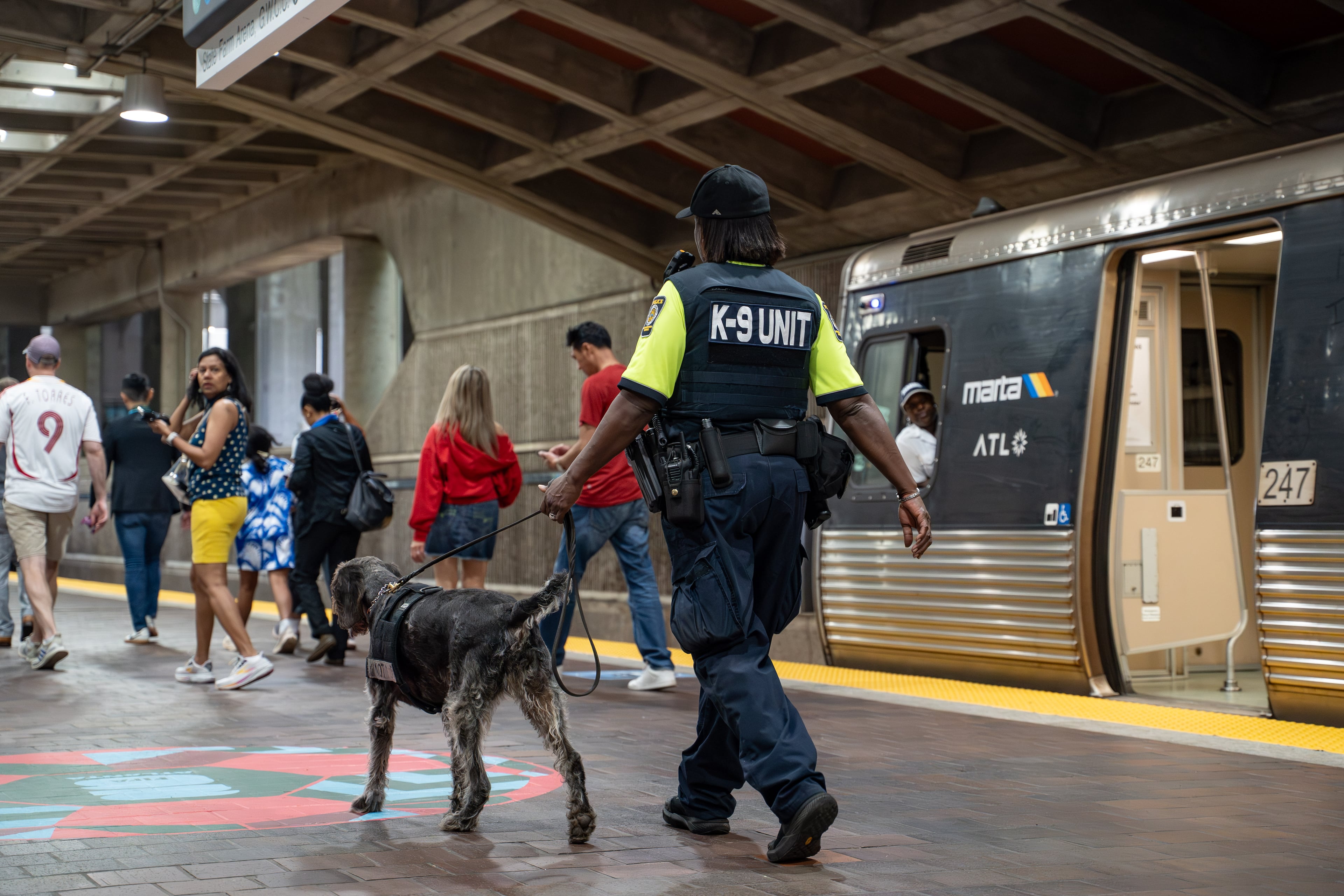 A MARTA Police officer and her k9 patrol the SEC District MARTA station as fans attend the first FIFA match held in Atlanta on Monday, June 15, 2026. (Ben Hendren for the AJC)