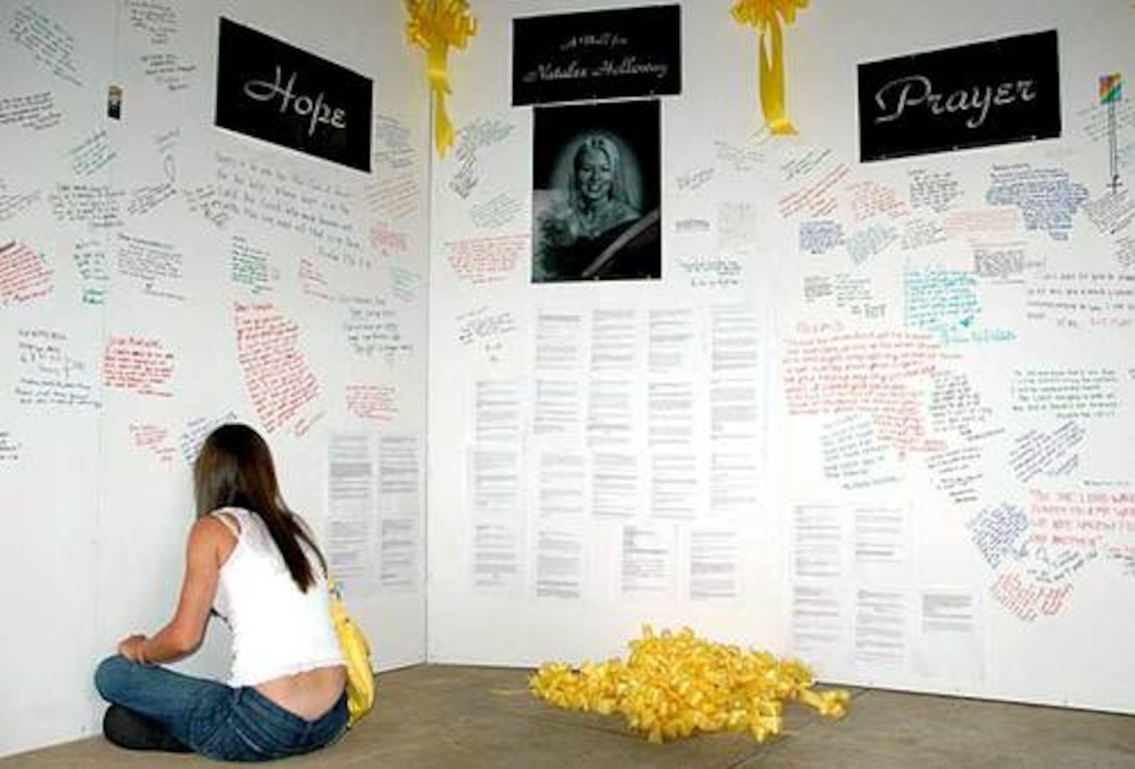 One of Natalee Holloway's friends signs a "wall of hope" erected for the missing Alabama teen in Mountain Brook, Ala., in June 2005.