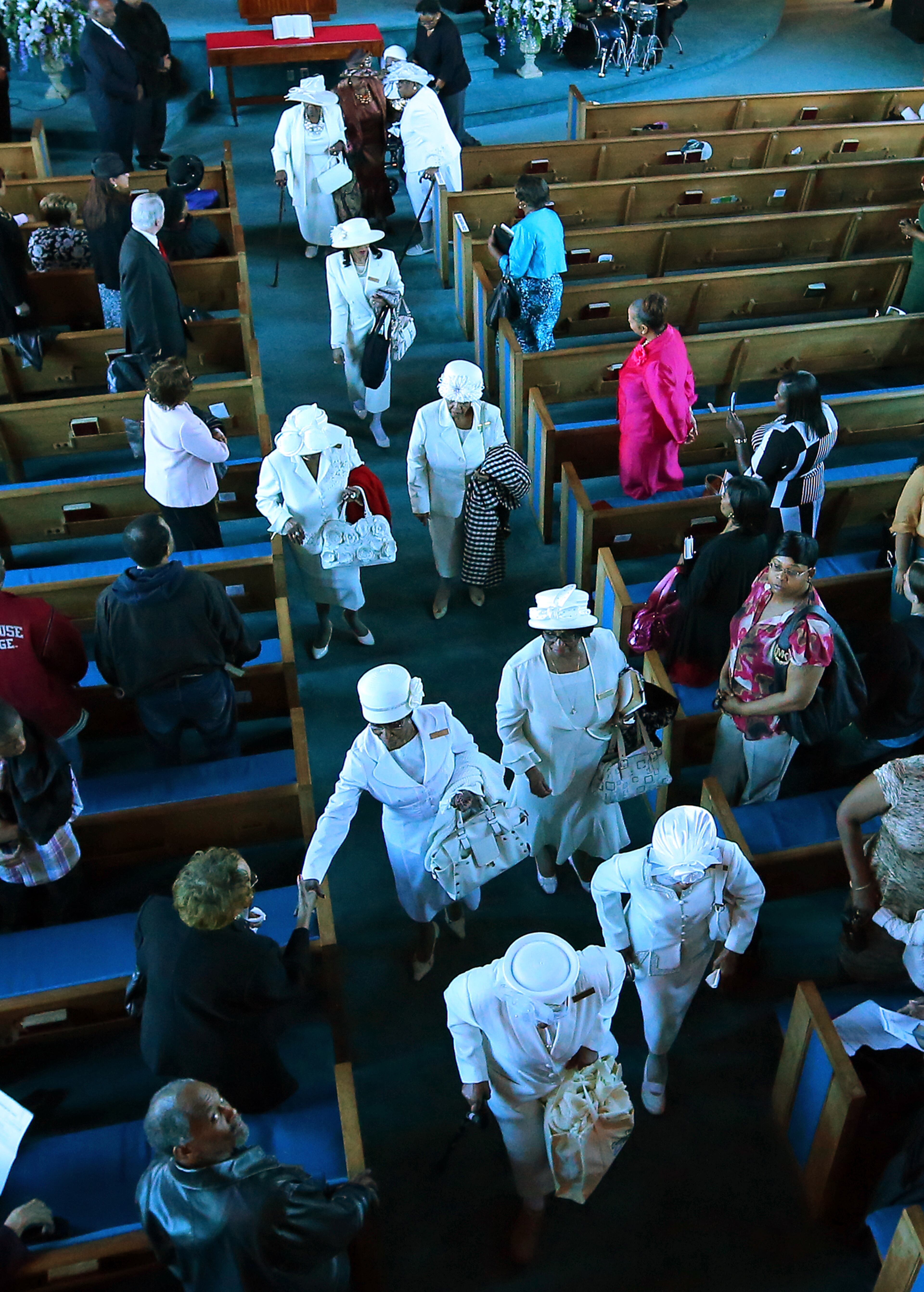 Mount Vernon Baptist Church concludes their final worship service with a symbolic "Exit Ceremony" with women of the church dressed in white joining the processional out of their sanctuary on Sunday, March 9, 2014, in Atlanta. It was the last time members will gather at the church, which will make room for the Falcons new stadium.