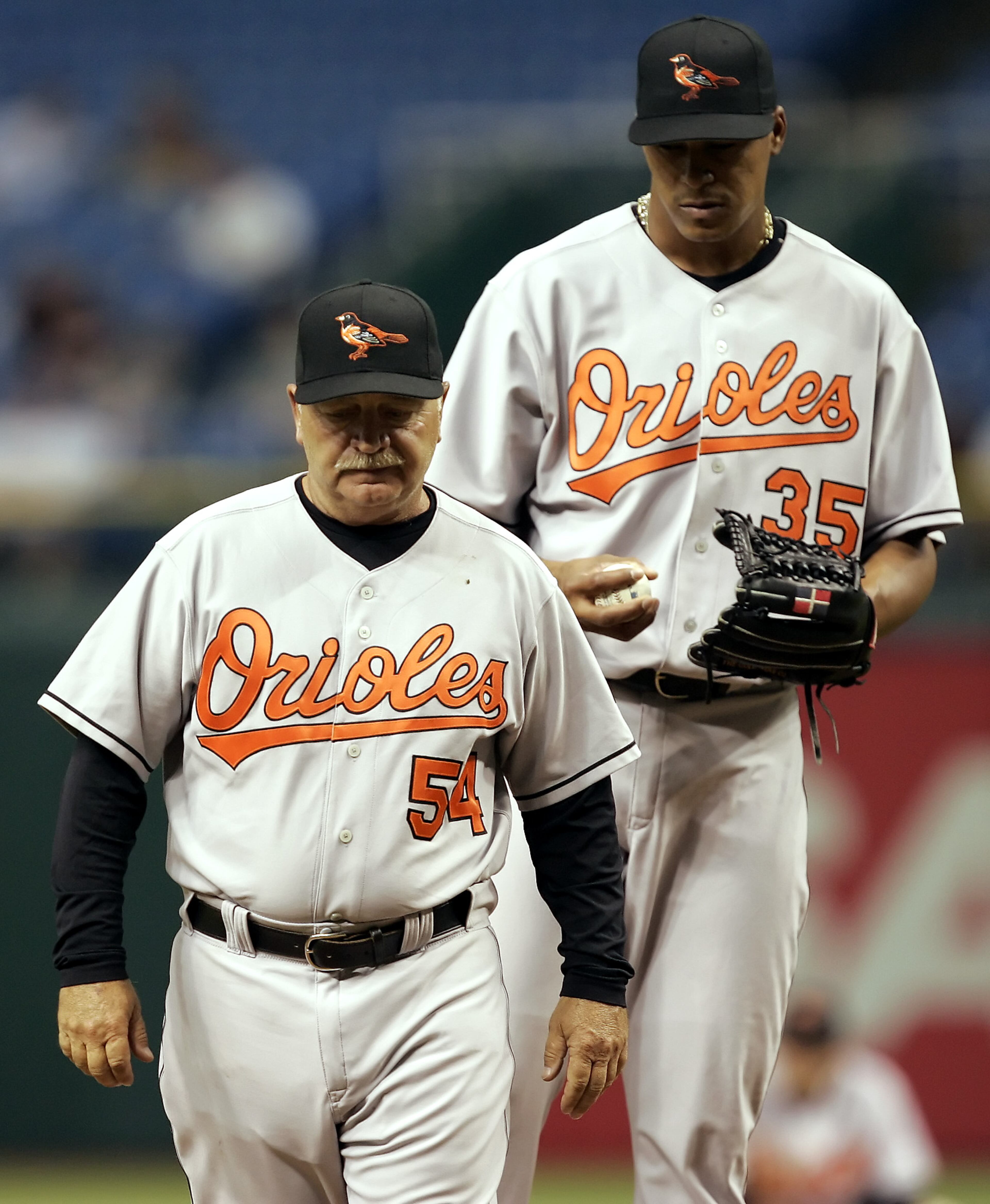 Orioles pitching coach Leo Mazzone (54) heads back to the dugout in the third inning after talking with pitcher Daniel Cabrera in 2006.
