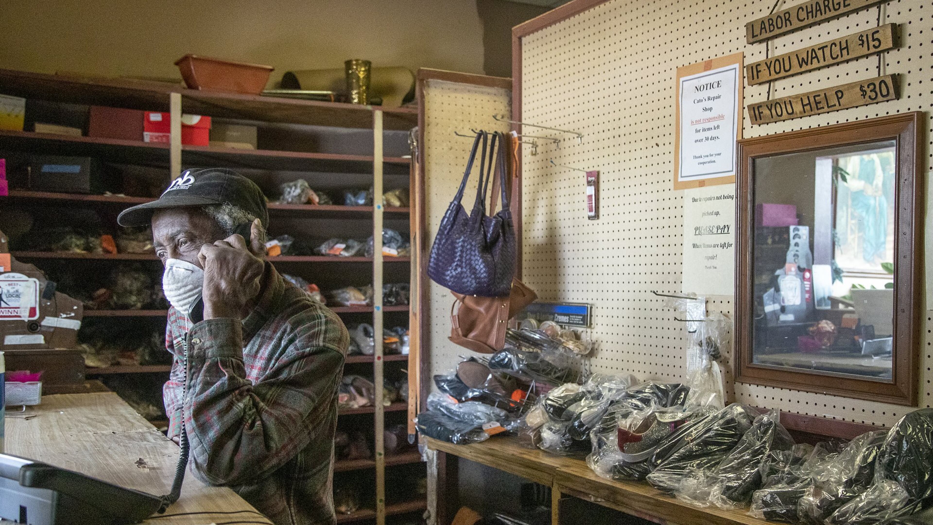 Joe Jordan, 82, owner of Cato Shoe Repair, answers a phone call from a customer inside his store in Atlanta. He and his wife, Hattie, have been repairing shoes since the 1960s. In addition to shoes, they work on belts, purses, luggage and more. Atlanta has just opened applications for a program that would give grants to small businesses struggling with coronavirus-related costs. (ALYSSA POINTER / ALYSSA.POINTER@AJC.COM) AJC FILE PHOTO