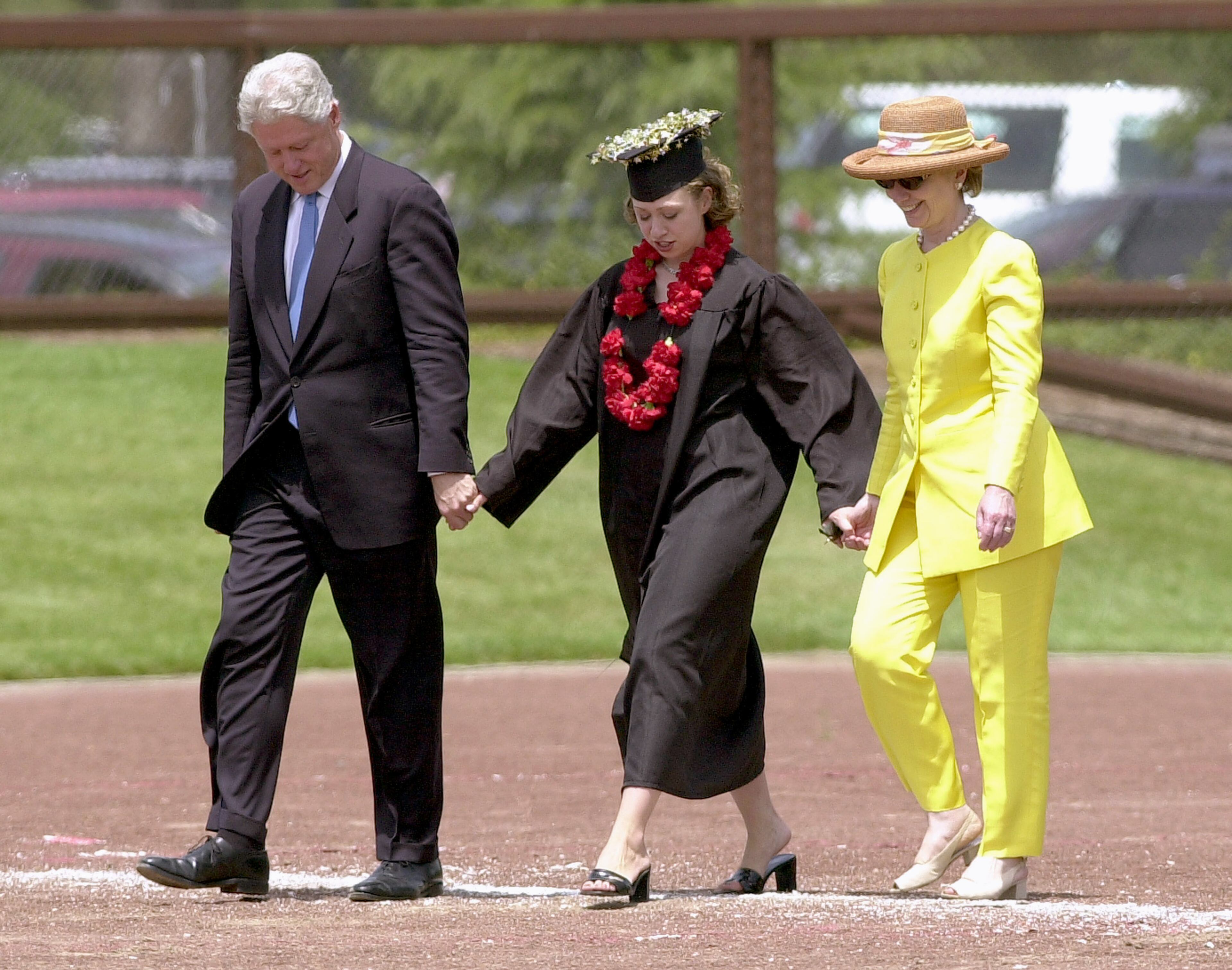 Former U.S. President Bill Clinton, daughter Chelsea Clinton center, and U.S. Senator Hillary Clinton walk hand in hand June 17, 2001 in Stanford, California after Chelsea''s graduation from Stanford University. (Photo by Justin Sullivan/Getty Images)