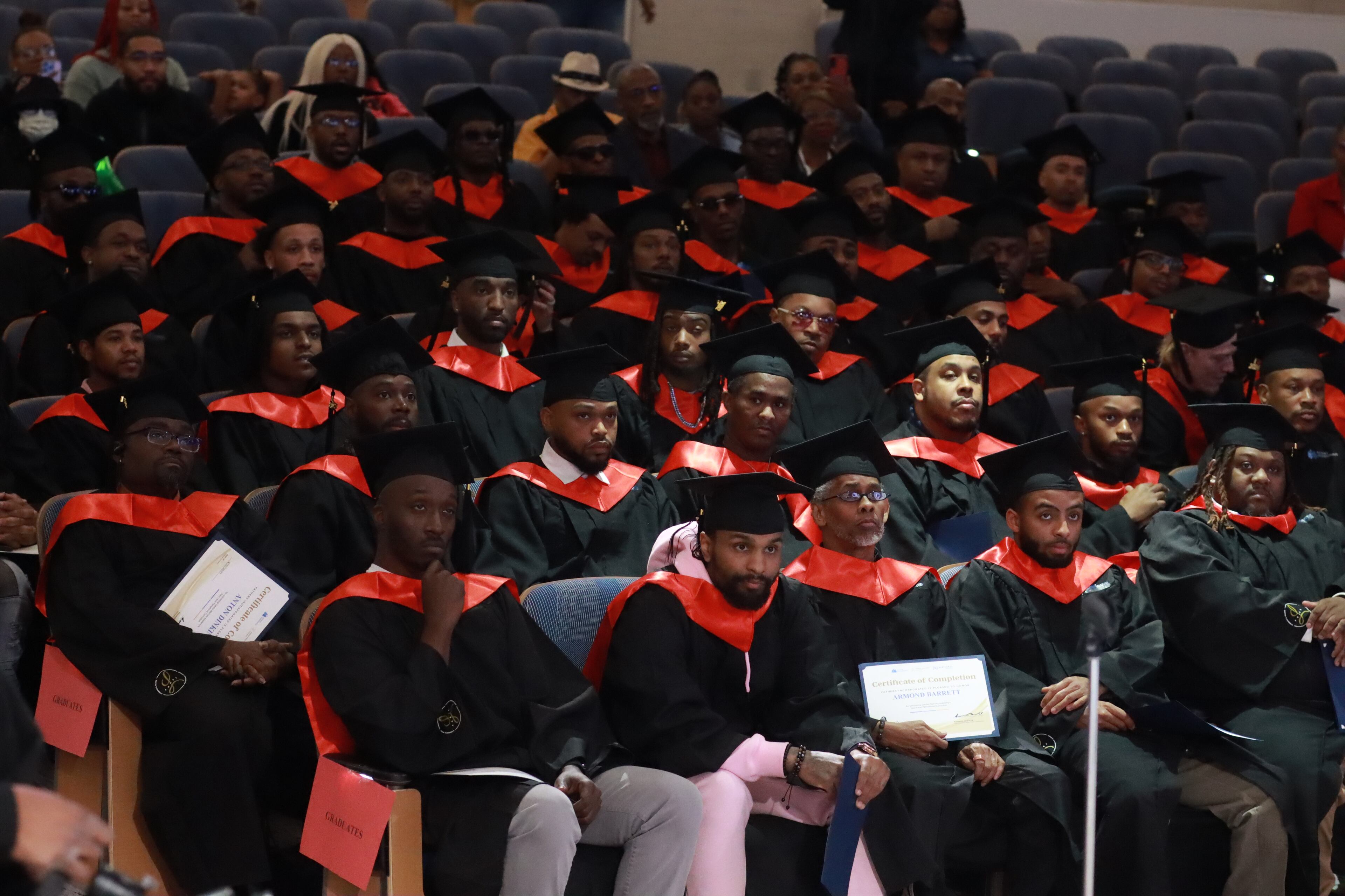 Graduates of Fathers Incorporated listen to a speech during their graduation ceremony (Courtesy of Fathers Incorporated)
