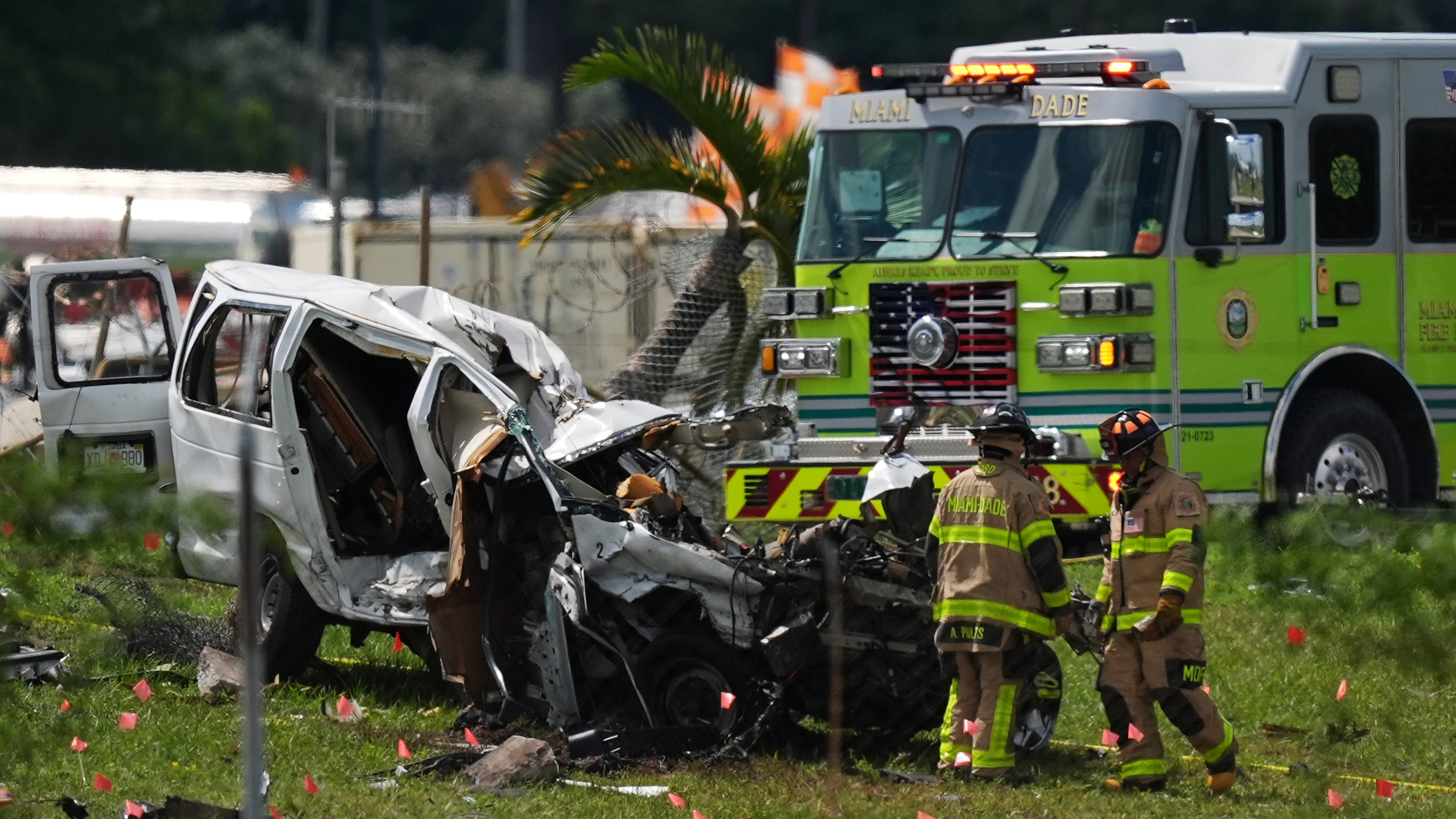 Miami Dade Fire Rescue officials inspect a damaged vehicle two days after an Amazon cargo plane overshot a runway at Miami International Airport, Tuesday, Sept. 8, 2026, in Miami. (AP Photo/Rebecca Blackwell)