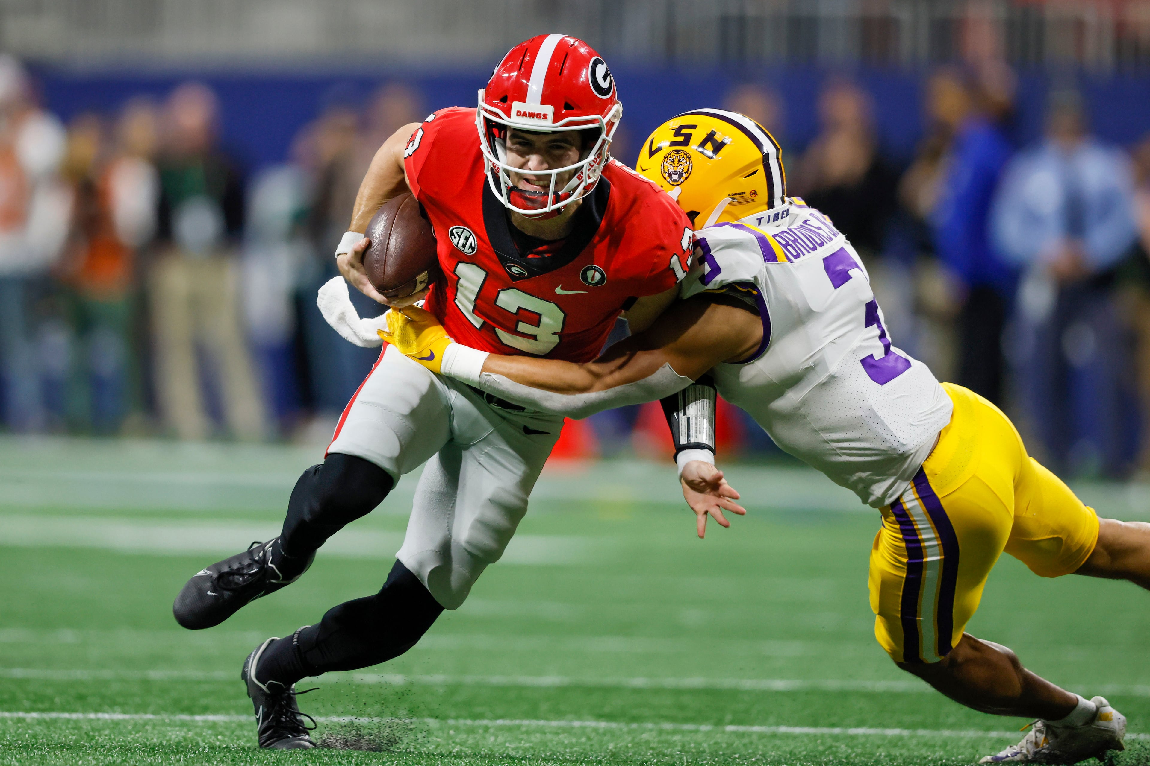 Georgia Bulldogs quarterback Stetson Bennett (13) runs against the LSU Tigers during the second half of the the SEC Championship game at Mercedes-Benz Stadium, Saturday, December 3, 2022, in Atlanta. (Jason Getz / Jason.Getz@ajc.com)