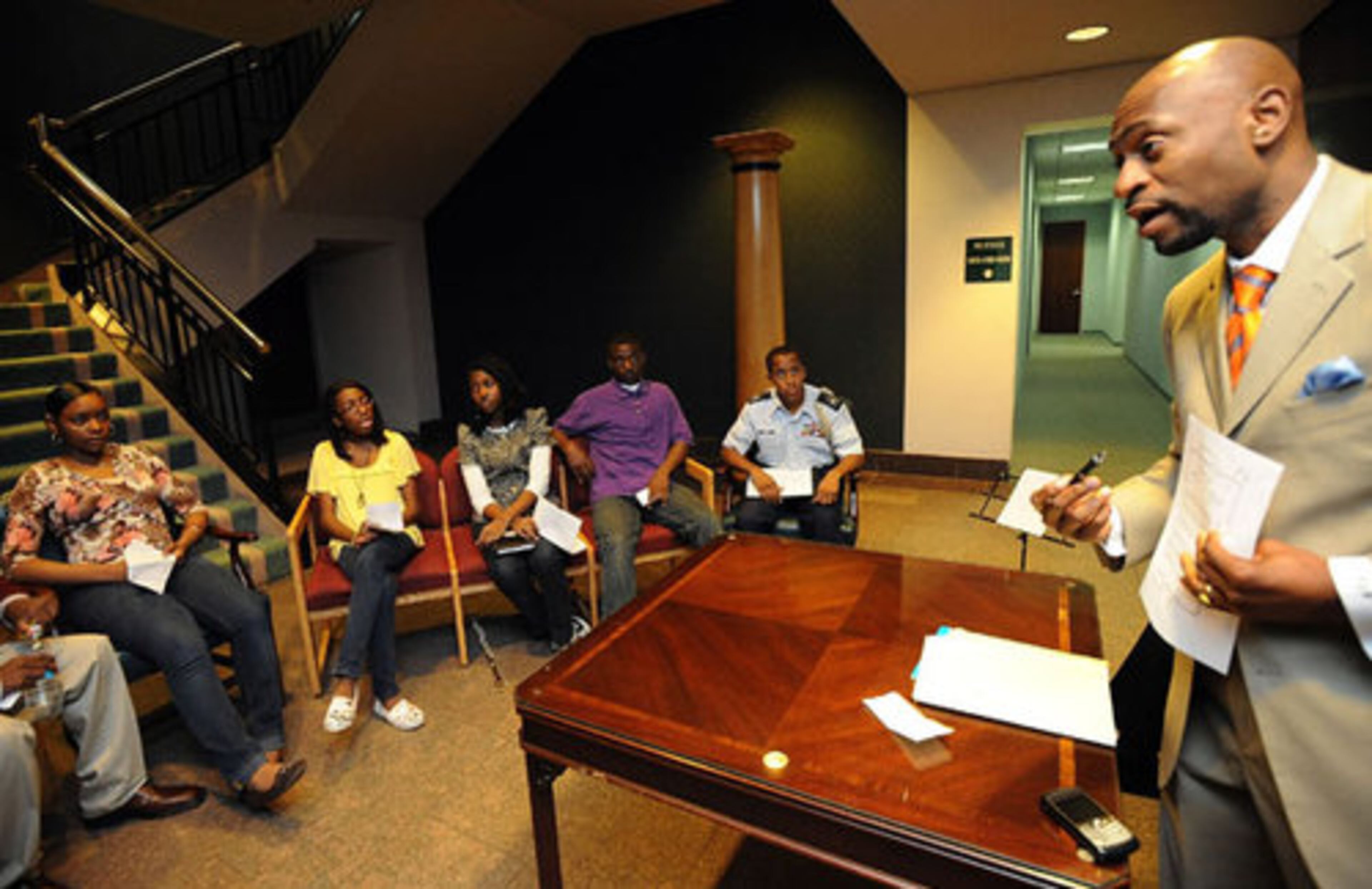 Nathan Wade (right) talks to young people during a meeting of Blacks United for Youth-Cobb's leadership academy. BUY-Cobb is the countys equivalent of 100 Black Men.