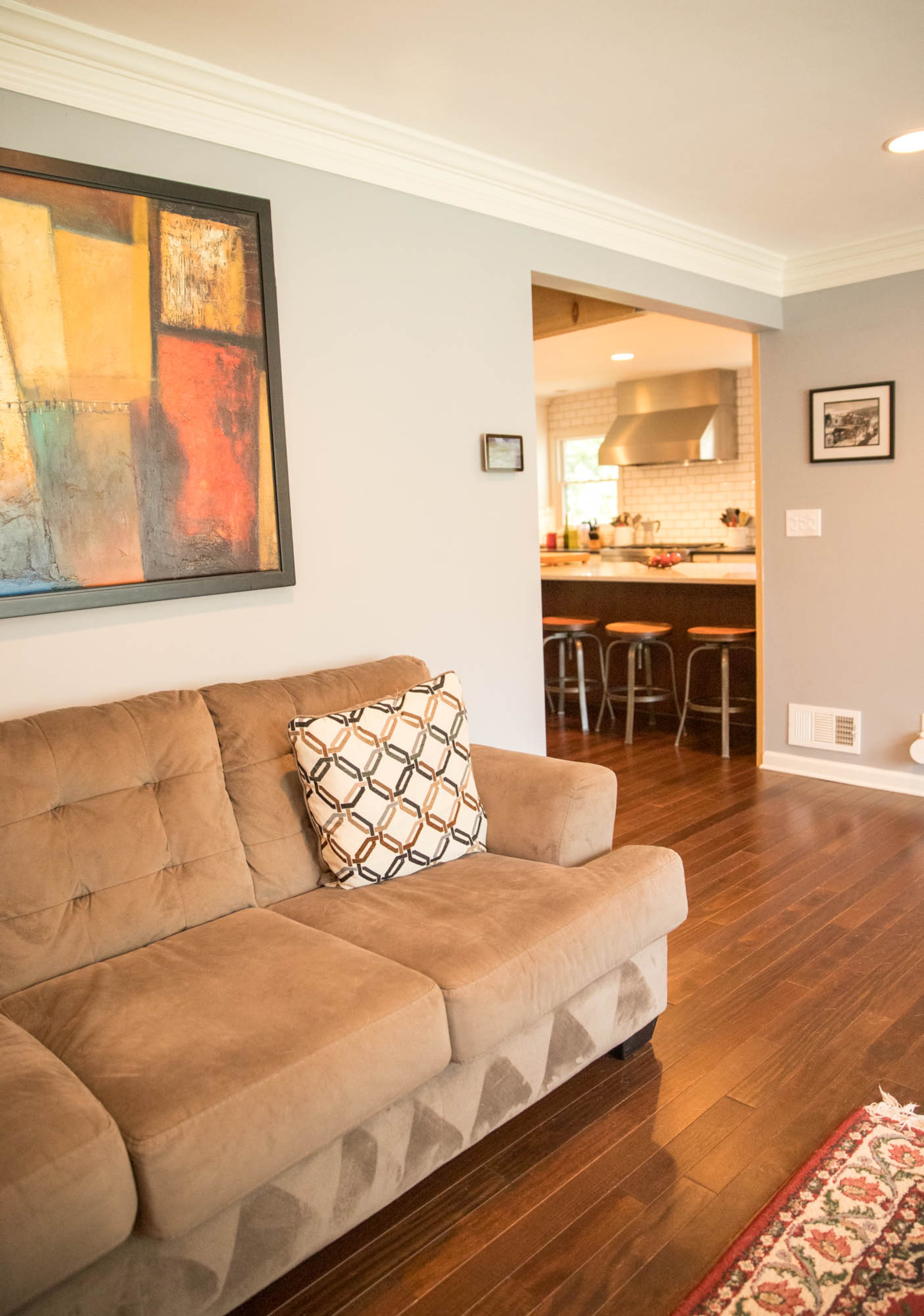 Adam Perry and Ben Ratossa selected a sofa from Ashley HomeStore and art from Finders Keepers Consignments to complete the seating area in the living room in their DeKalb County home.