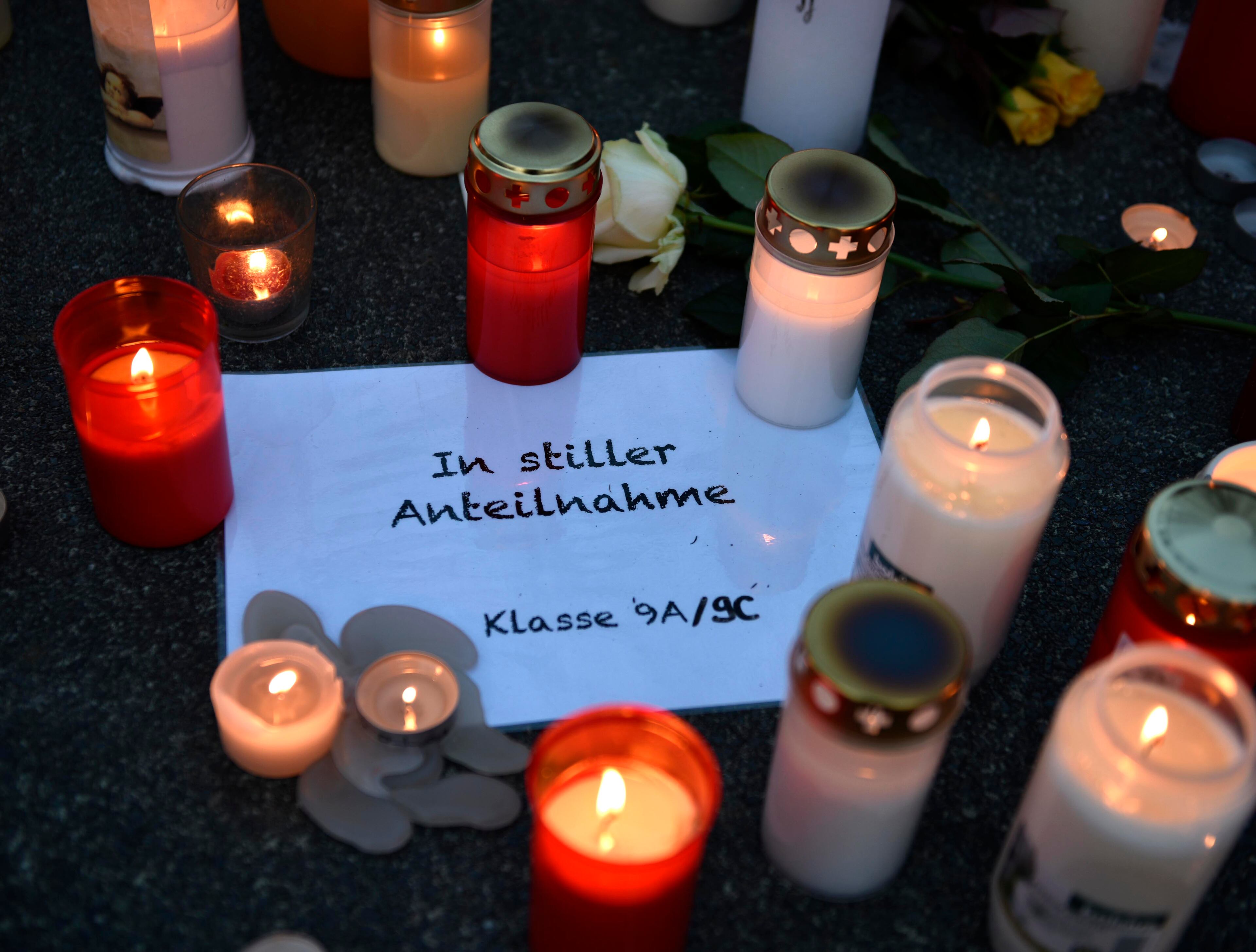 Candles sit on a paper reading "in silent memory, class 9a/9c" in front of the Joseph-Koenig Gymnasium in Haltern, western Germany Tuesday, March 24, 2015. A Germanwings plane from Barcelona crashed on its way to Duesseldorf over the French alps, 16 school children and 2 teachers from Haltern were among the 150 people on board. (AP Photo/Martin Meissner)