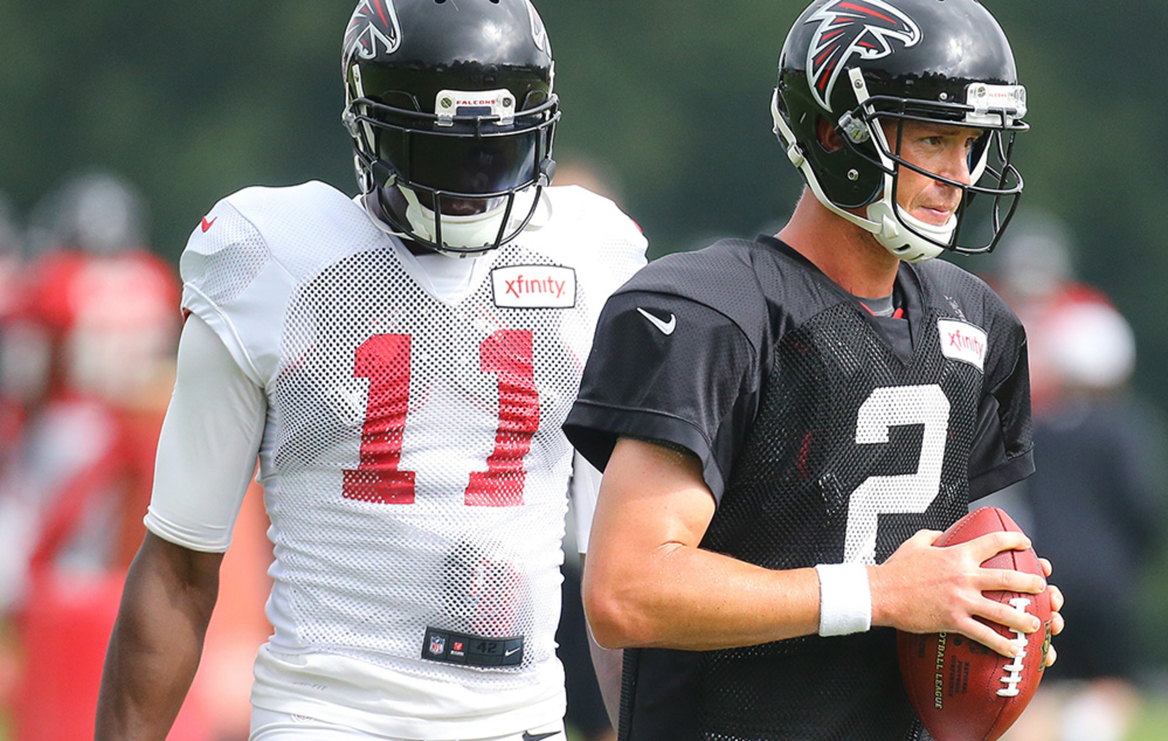 Falcons quarterback Matt Ryan and wide receiver Julio Jones prepare to run a play during team practice Tuesday in Flowery Branch.