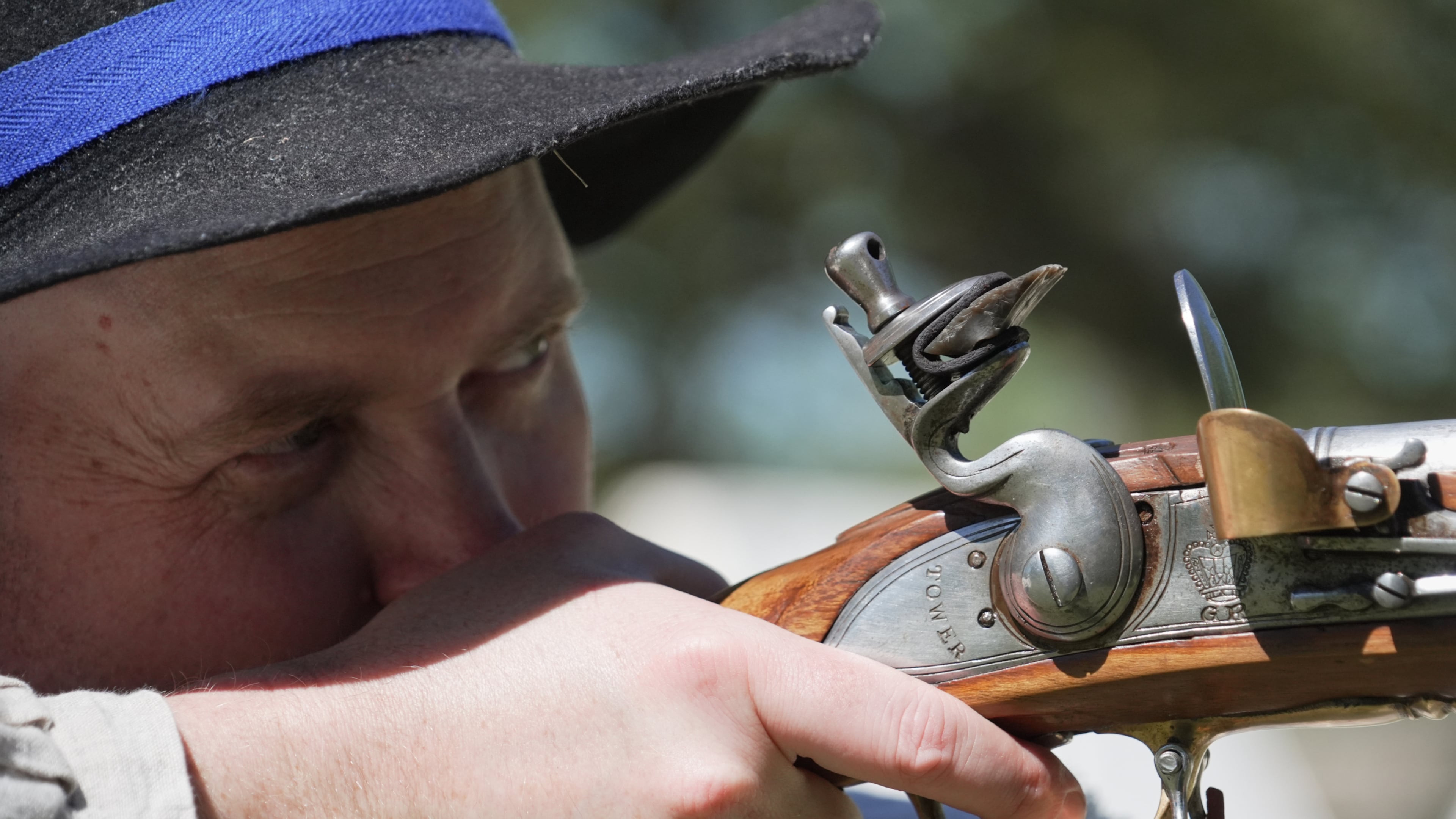 A.J. Drake, a historic interpreter, aims his Brown Bess flintlock replica musket during a Revolutionary War event in Halifax, N.C., on April 10, 2026. (AP Photo/Allen G. Breed)