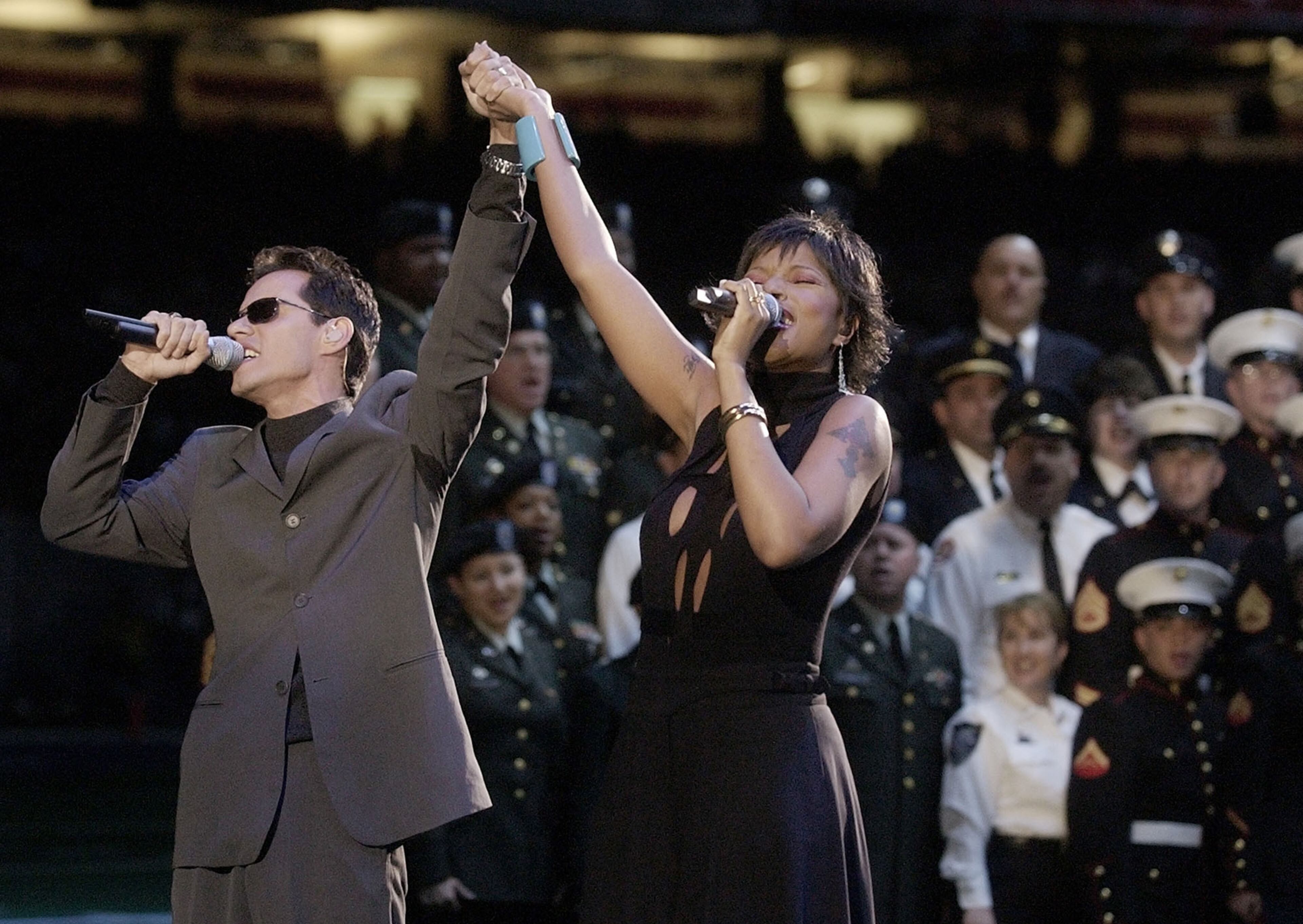 Marc Anthony, left, and Mary J. Blige sing during pregame ceremonies at Super Bowl XXXVI on Feb. 3, 2002, in New Orleans.