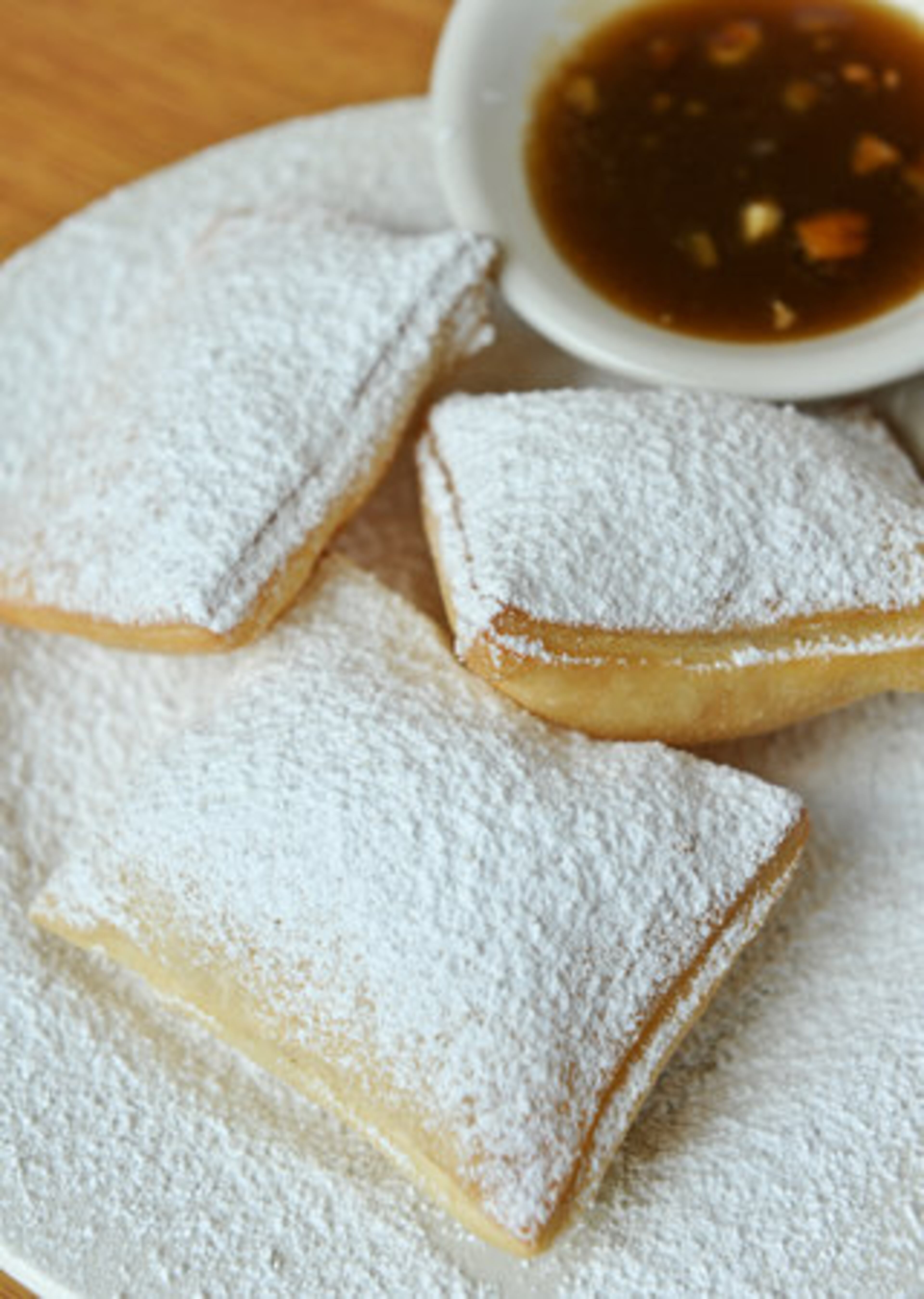Beignets with pecan praline sauce at The Beignet Connection in Atlanta, owned by the owner of now-closed Atlanta spot Huey's. "Attempting to duplicate the menu and theme of another restaurant seems to hamper this one from developing its own personality," Jenny Turknett writes. One star.