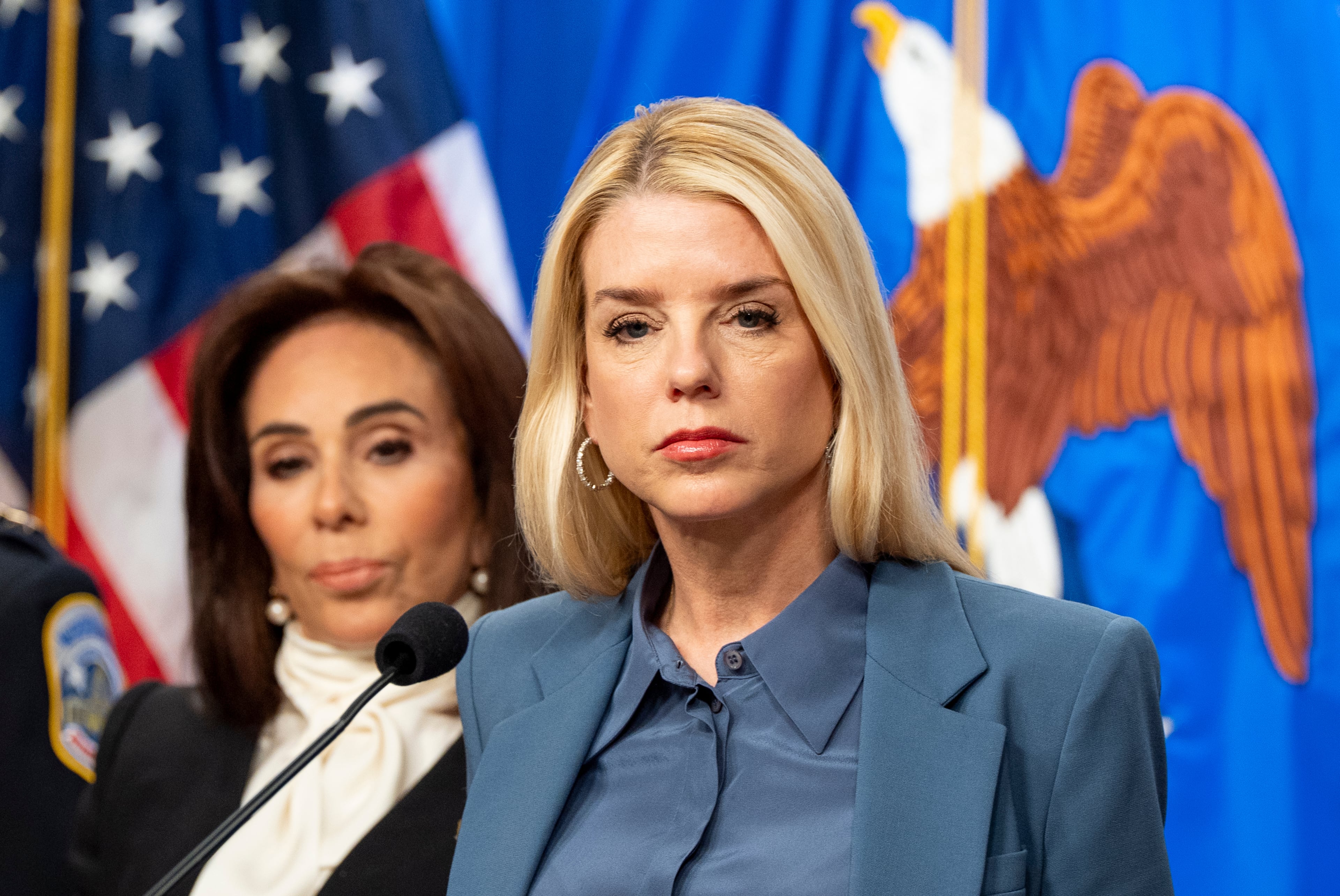 Attorney General Pam Bondi (center), with U.S. Attorney Jeanine Pirro behind, pauses while speaking during a news conference at the Department of Justice on Thursday, Dec. 4, 2025, in Washington. (Alex Brandon/AP)