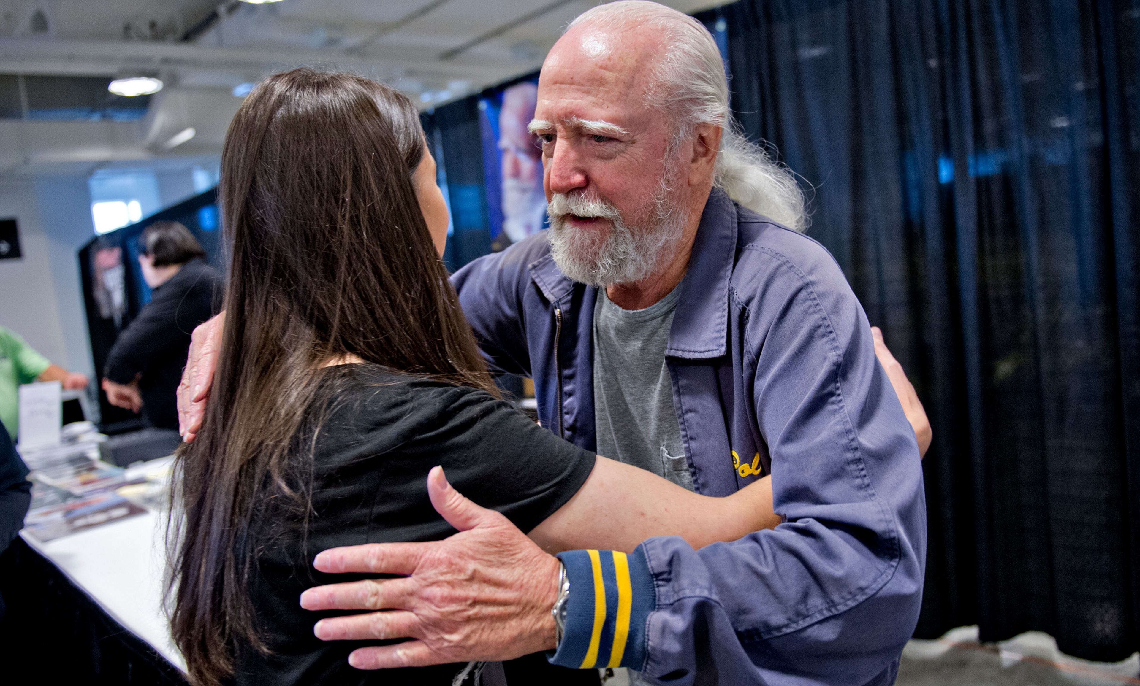Scott Wilson (right), who played Herschel on the Walking Dead, gives Vanessa Barfield a hug as he signs autographs during Walker Stalker Con in Atlanta on Sunday, Oct. 19, 2014. JONATHAN PHILLIPS / SPECIAL