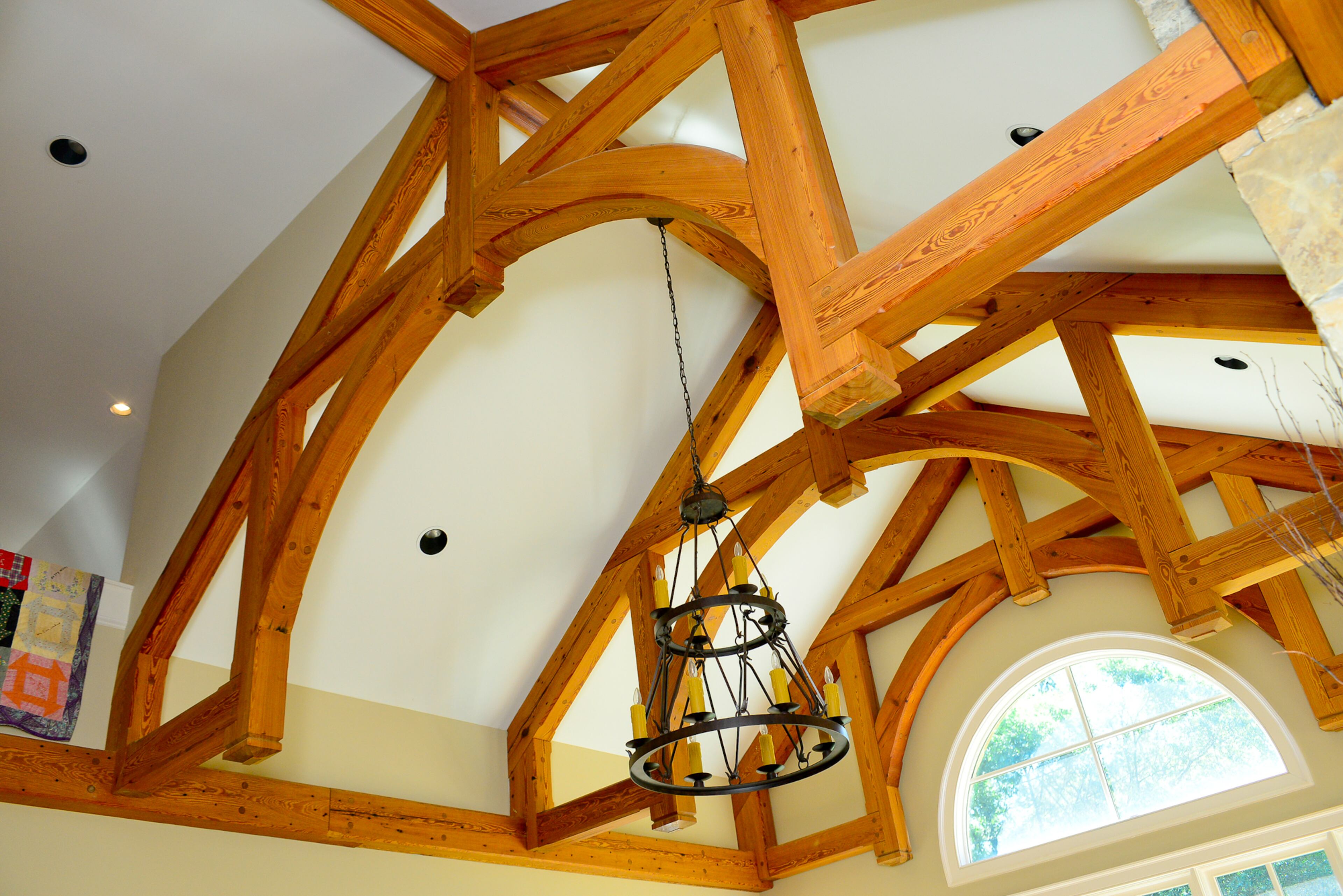 Homeowner Ed Barber and Jason Newberry of Legacy Wood Products in Watkinsville designed the modified hammer-beam truss ceiling and installed it. They used beams from an old warehouse in downtown Atlanta that Barber believes dates to the 1860s. The chandelier was sourced from Design Lighting Group.