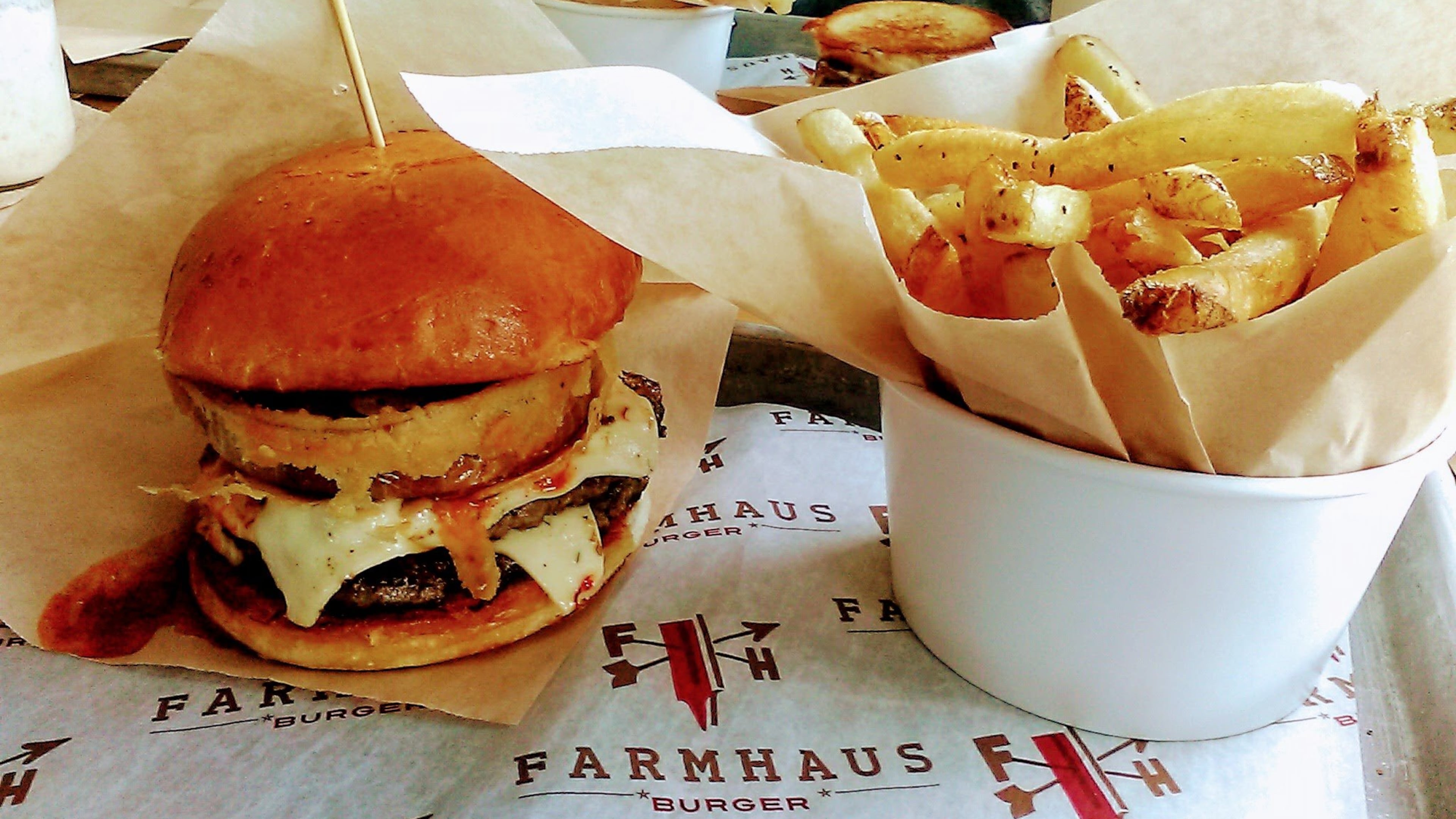 The Chili Cheese burger with a buttermilk battered onion ring on an artisan bun with a side of hand-cut Russet fries at Farmhaus Burger in downtown Augusta. CONTRIBUTED BY BLAKE GUTHRIE